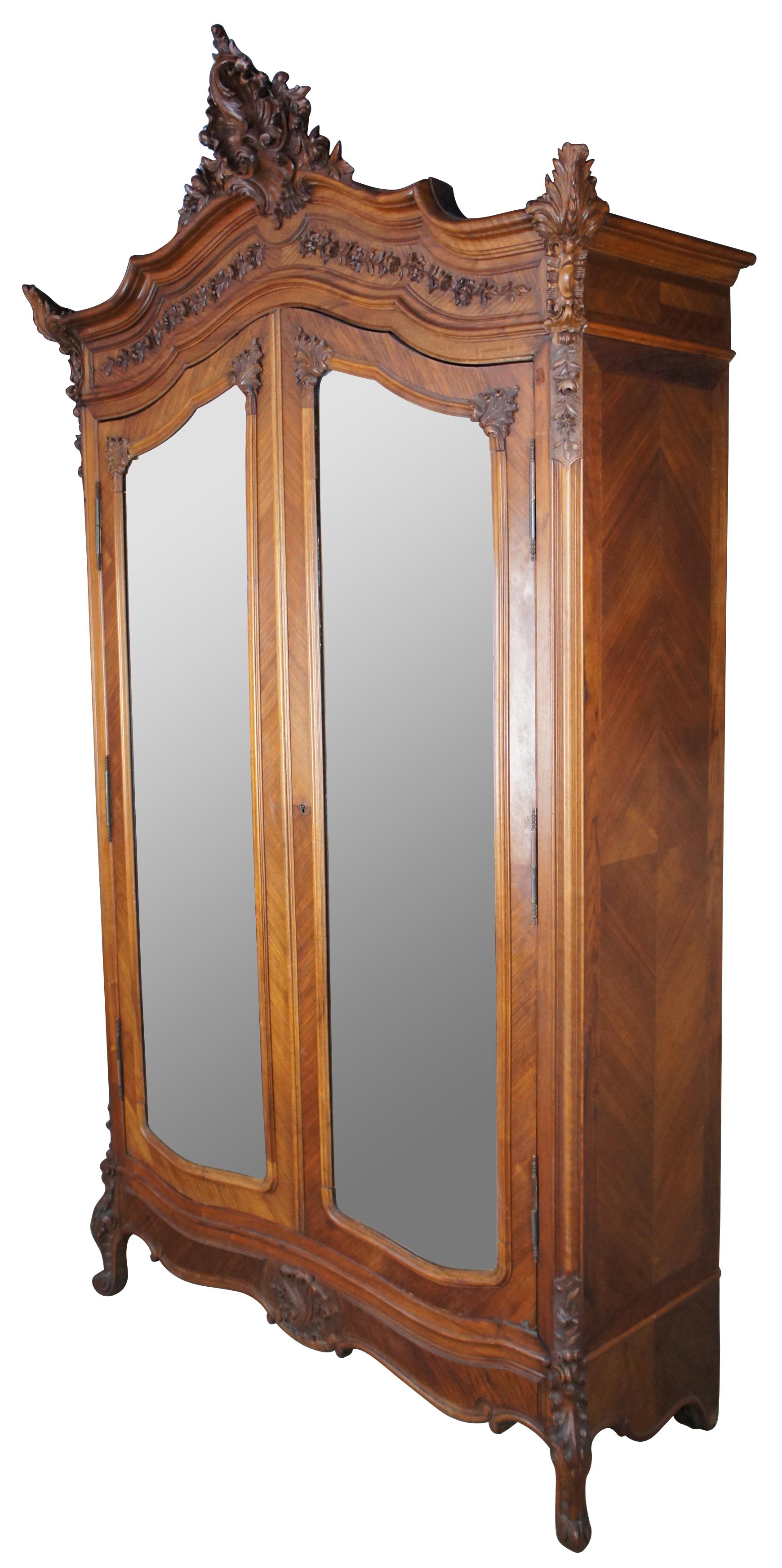 Monumental late 19th century Louis XV knockdown armoire by Bedel & Cie of Paris, France Made of walnut with a beautiful matchbook wood grain. Features serpentine aprons with magnificent foliate, acanthus and baroque inspired carvings. Includes large