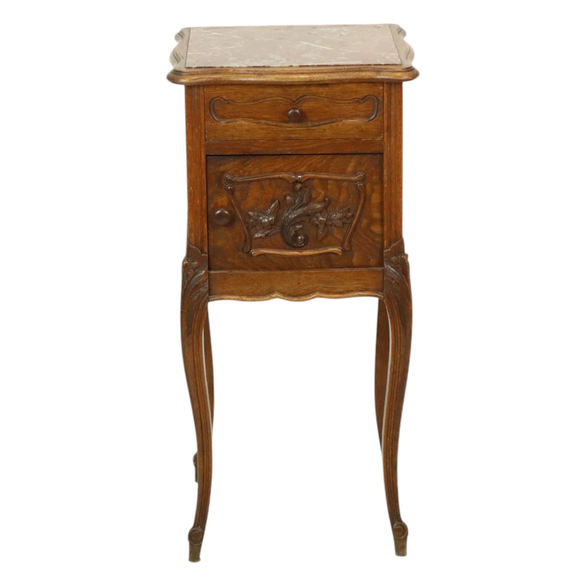 Beautiful antique bedside table, night table made of (probably) oak with red marble top, graceful carved acanthus decoration and elegant legs, completely in Louis XV style, circa 1900, France.

This bedside table or side table is ideal to use as a