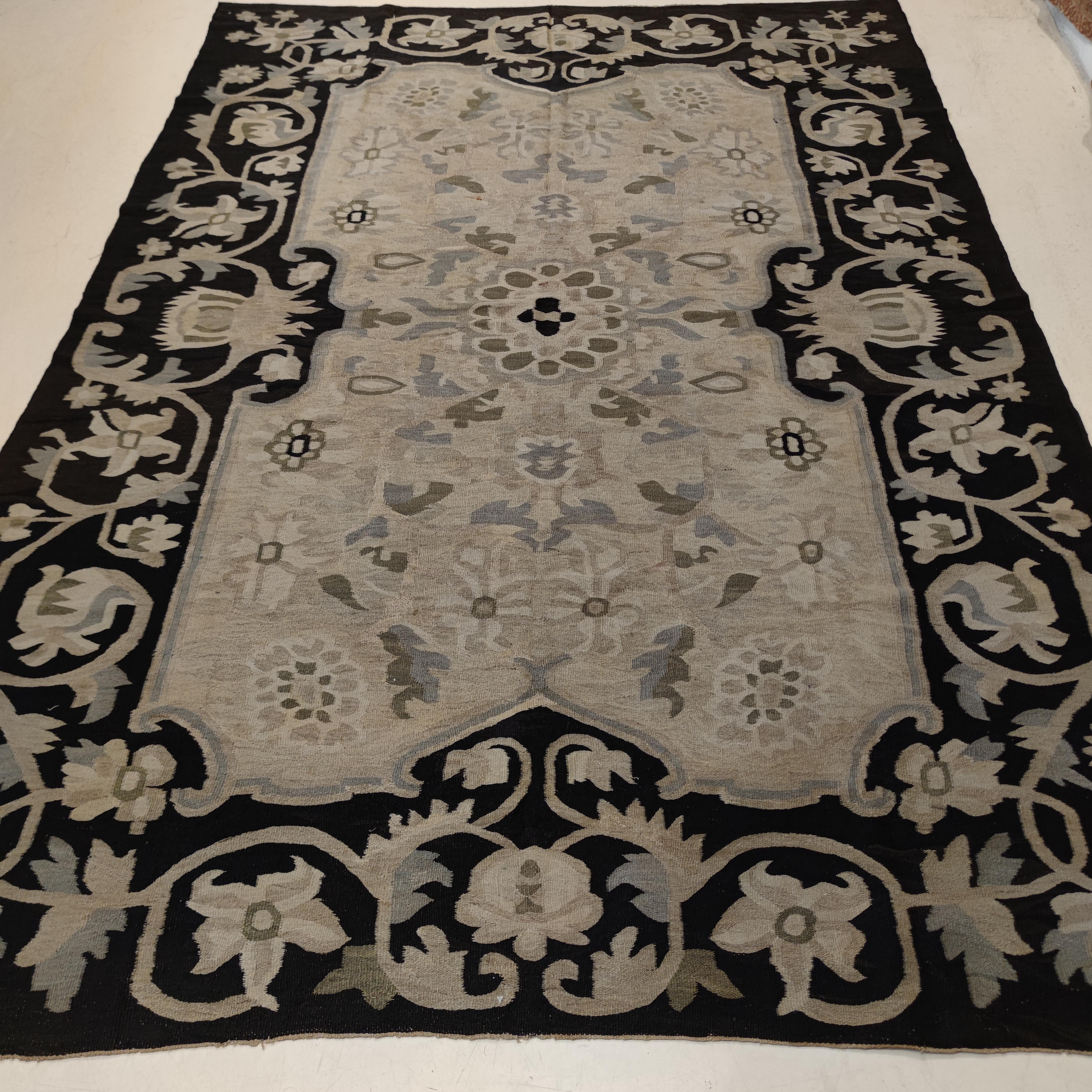 beige rug with black border