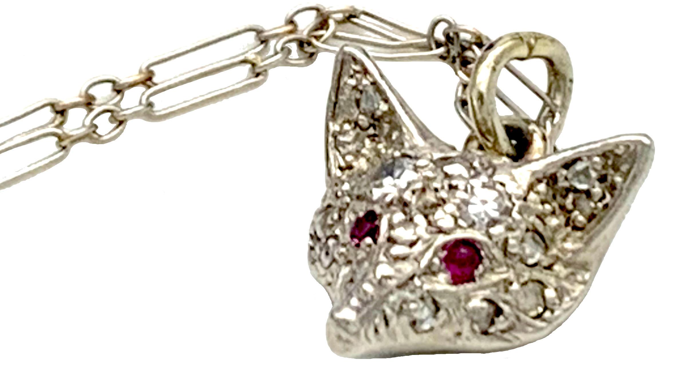 This delicate platinum pendant necklace was created around 1910. The head of the little fox is set with rose cut diamonds. The foxes eyes are made out of round cut rubies. The platinum necklace closes with an 18K yellow gold bolt ring.
The length of