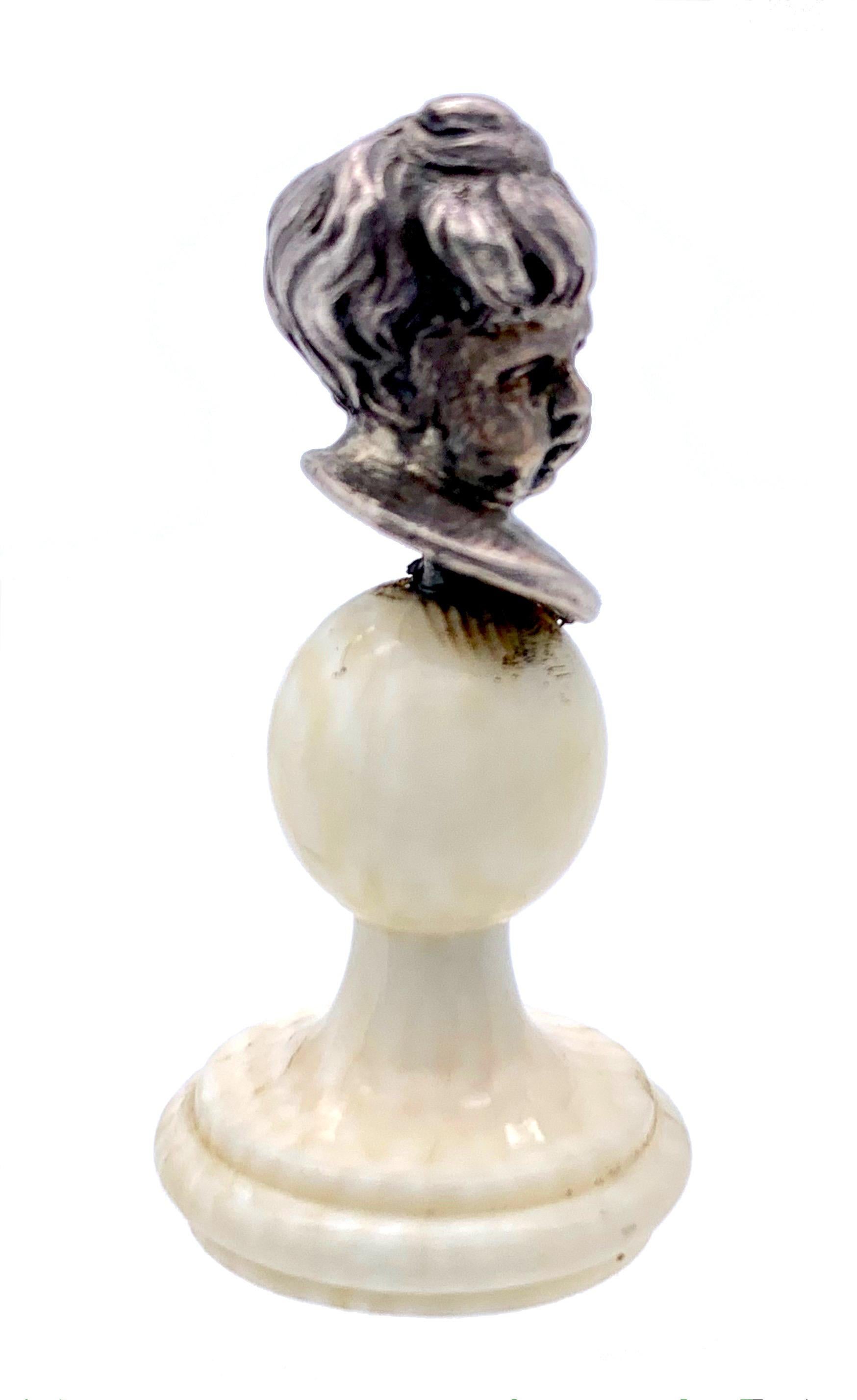 The beautifully modelled bust of this charming little cherub has been handcrafted in the last decad of the nineteenth century. the little bust  is cast out of silver. it has been mounted on a celluloid pedestal. 
l
