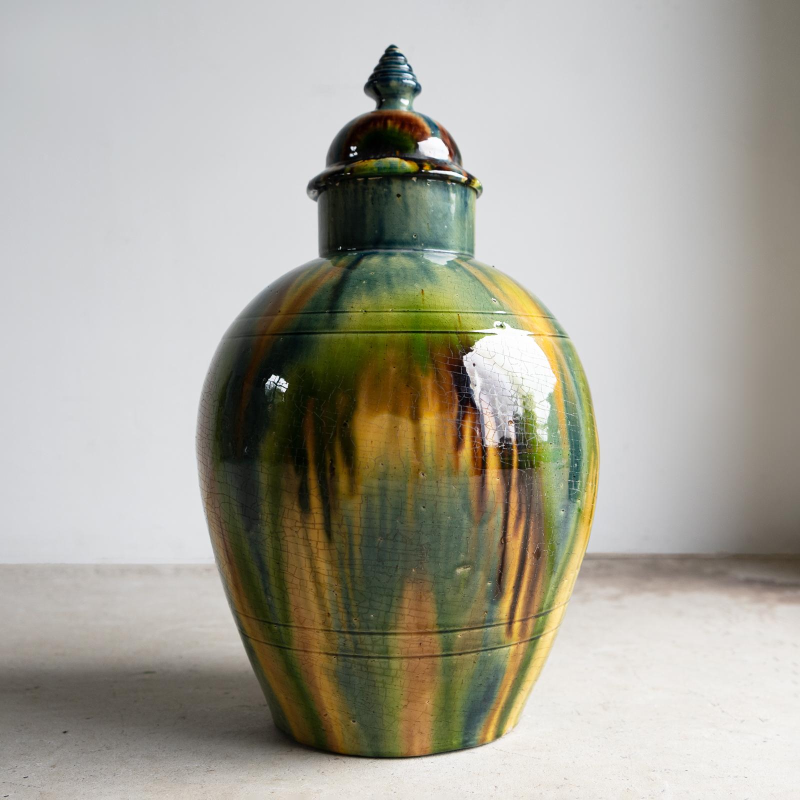 ANTIQUE FAIENCE LIDDED JAR/VASE/URN 

An impressive and decorative ceramic lidded jar or vase of large bulbous form with multicoloured drip glaze. 

Made by Faiencerie de Thulin near Mons in Belgium and dating from the early 20th century. Circa