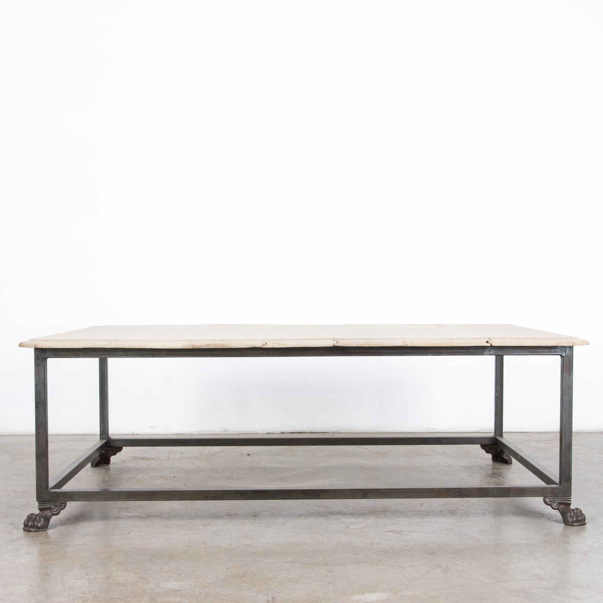 Composed from reclaimed furniture elements, an antique oak table top, and iron claw feet are recast as a stylish and contemporary coffee table. Decorative embellishment and an elegant tabletop profile add ornamental flair to a minimal shape.