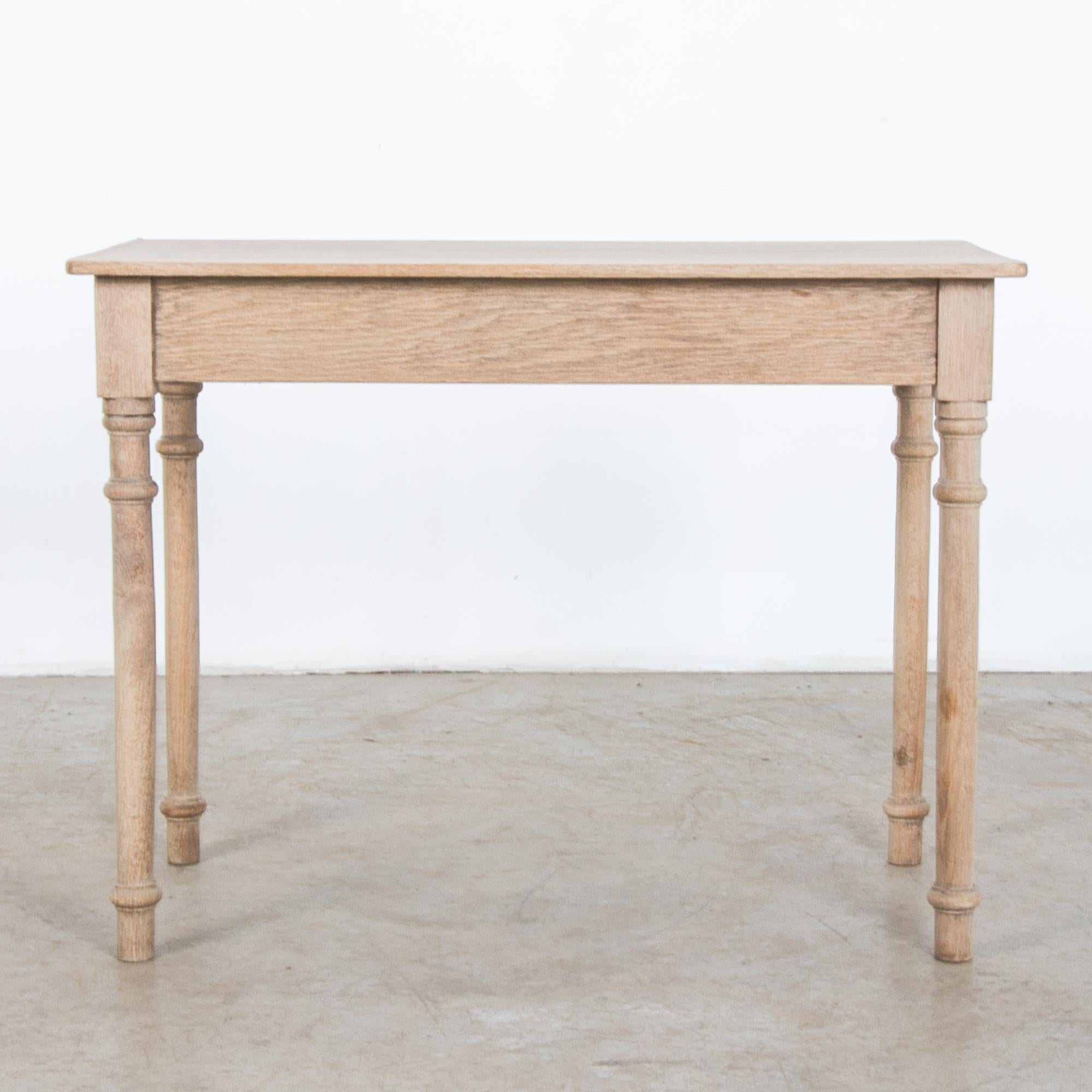 A simple oak table from Belgium, circa 1900. Rustic yet refined, this oak table is crafted after the traditions of local craftsmen. Away from the capital, carpenters interpreted the latest fashion in pared down styles, recalling their local ambiance