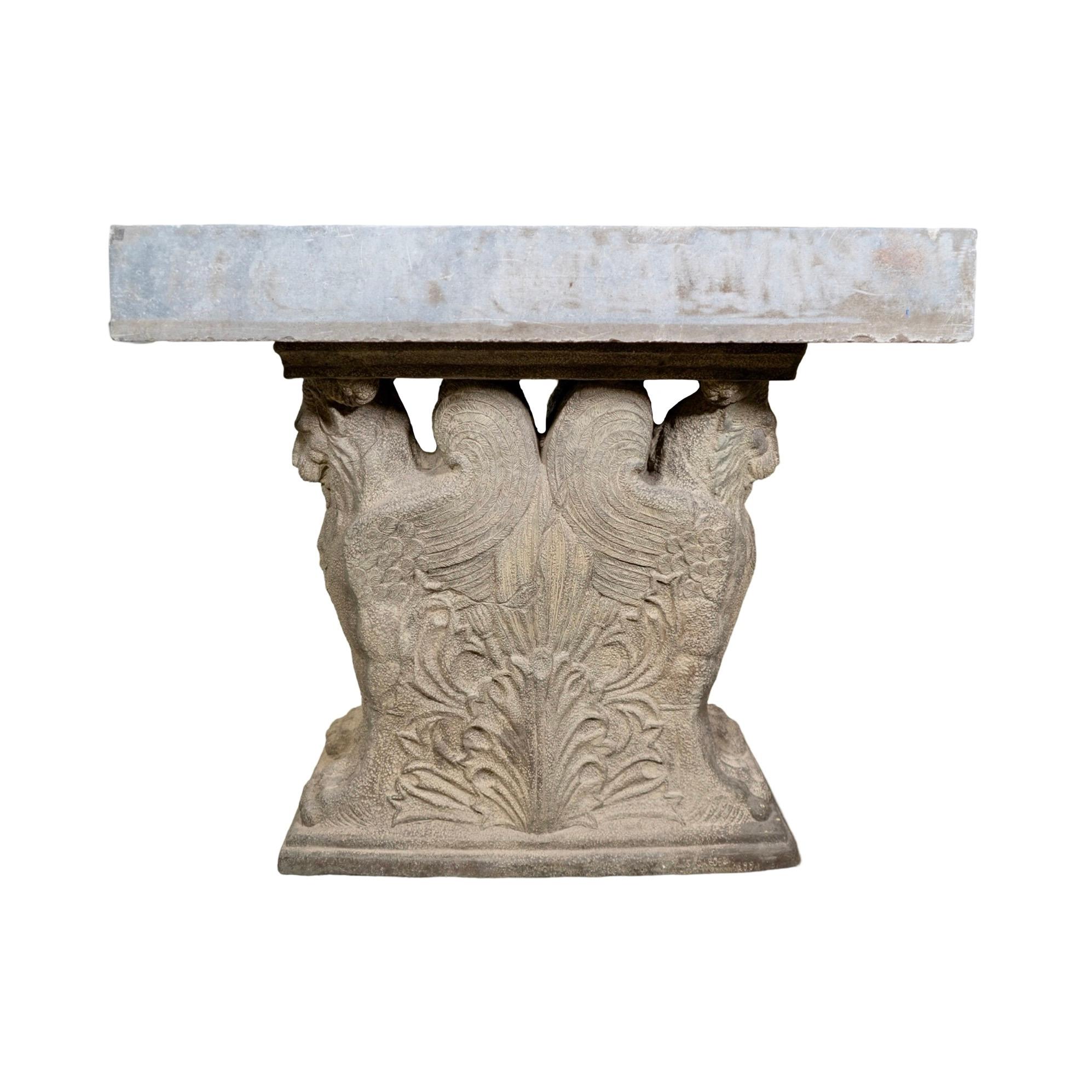 Enhance your outdoor space with this Antique Belgian Bluestone Sink and Base. This late 18th century sink, made out of bluestone, sits atop an intricately carved base with lion figure details. The bluestone composite base ensures durability, making