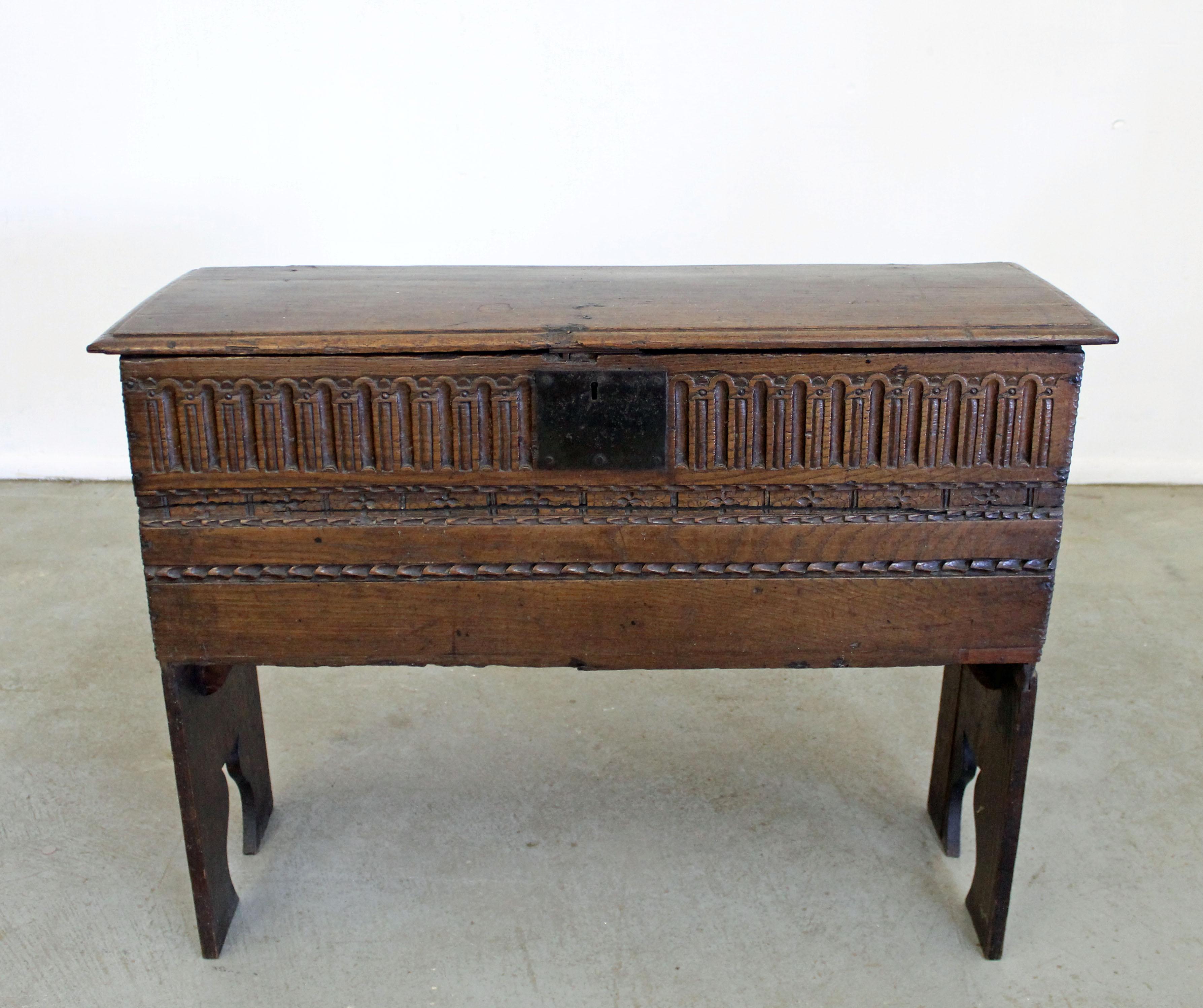 Offered is an antique 19th century dowry chest made of solid wood, which was used to store gifts for new brides, from Belgium or France. Features an ornate carved design with iron hinges and plenty of room for storage. It is in good, structurally