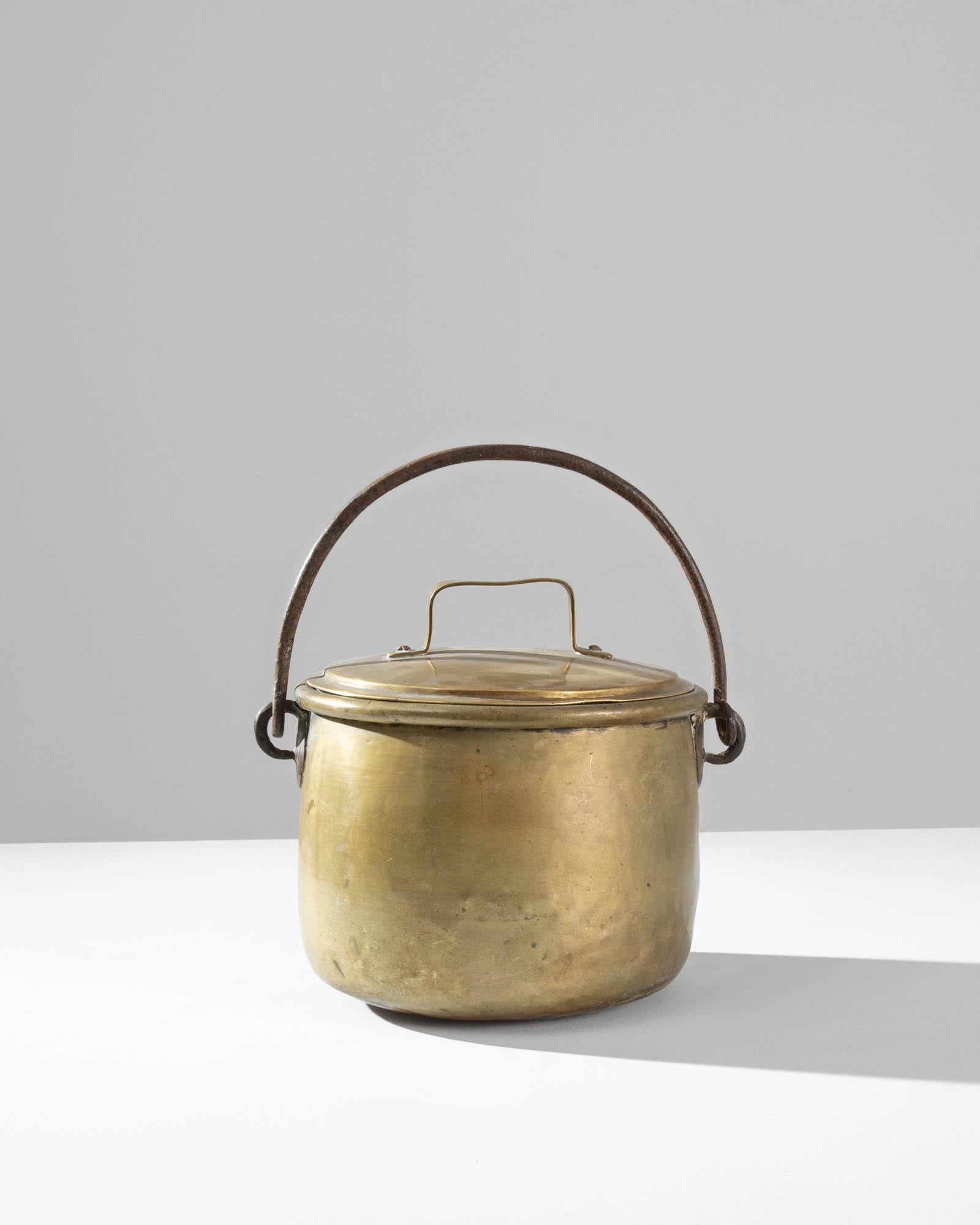 A brass pot from 19th century France. Totally handmade, this pot features a beautiful oxidized patina layering the original polished finish. These artisanally crafted pots were made with care and detail, along with high quality materials produced