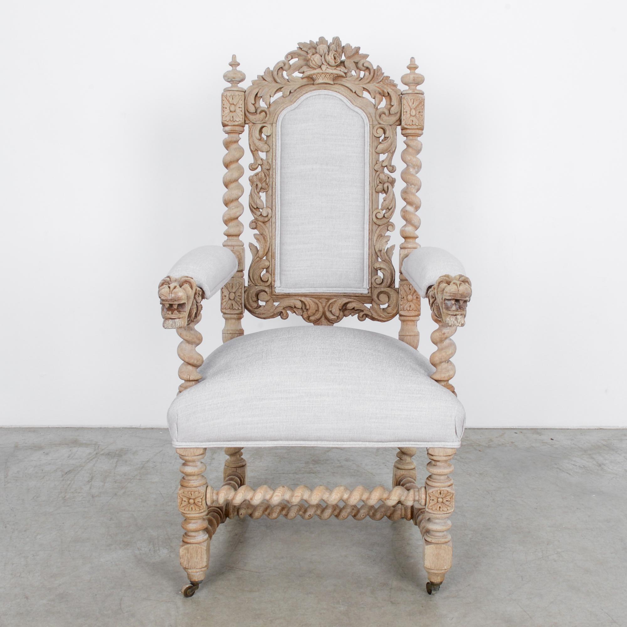 This wooden armchair with an upholstered seat, backrest, and armrests was made in Belgium, circa 1900. A combination of elaborate ornamentation and superior craftsmanship makes this a truly remarkable piece. Ornately carved with Flemish influence,