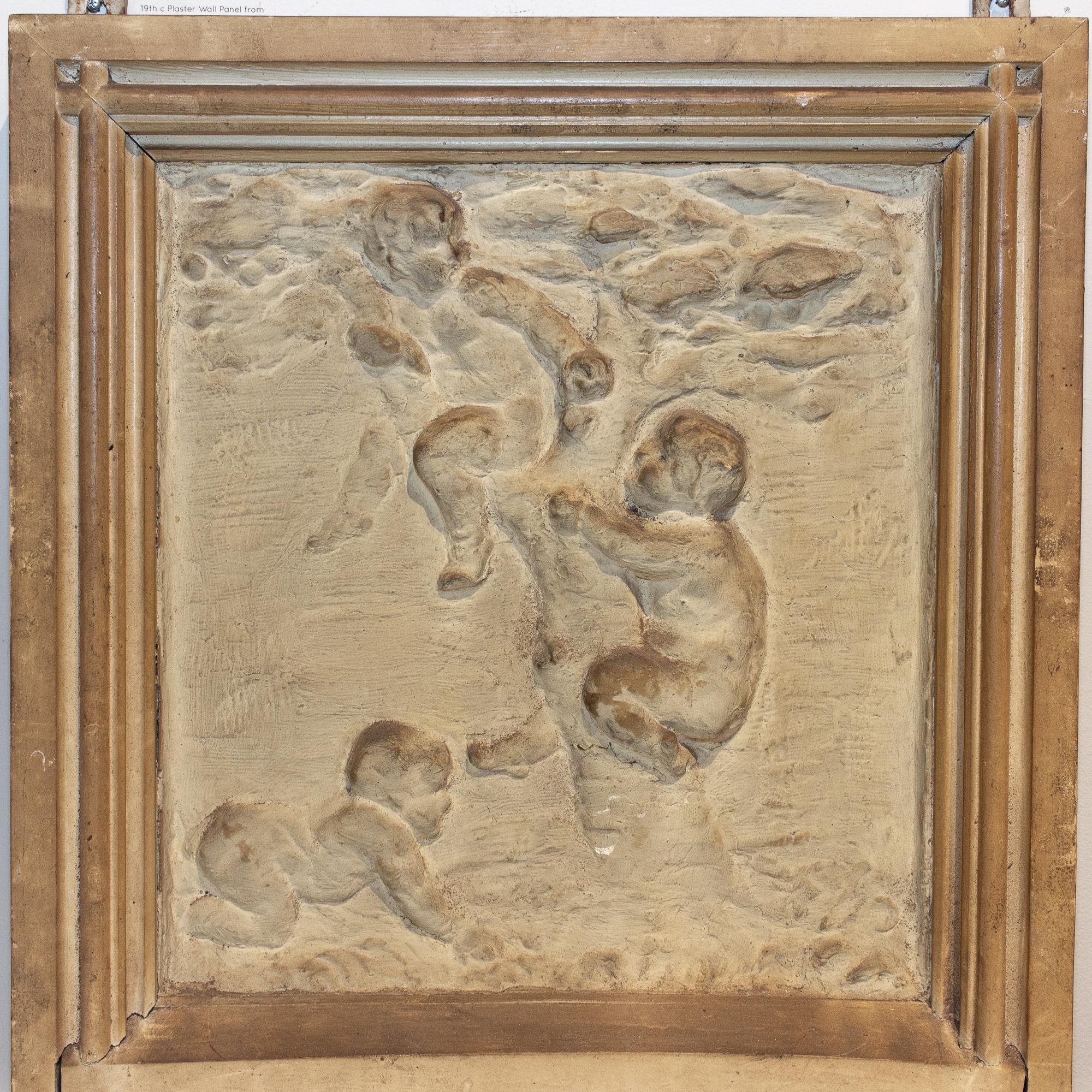 This is an antique plaster panel sourced in Antwerp, Belgium. This piece features an image depicting chubby infants at play in and around a tree (wings are not evident, so we are unsure if these are meant to be cherubim or other mythological