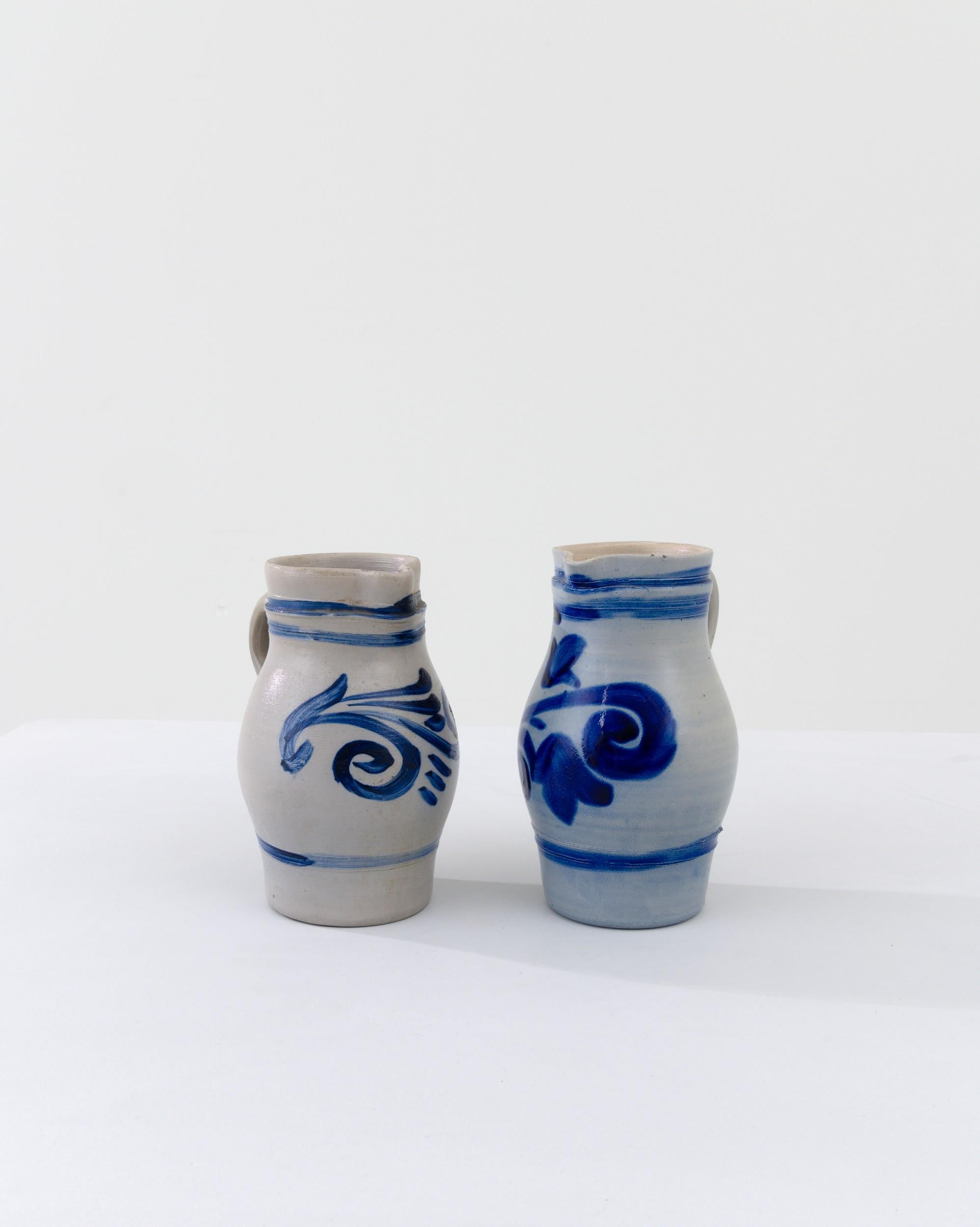 This pair of typical country pots is finished with a distinctive vivid blue salt glaze, enhancing the rounded clay base with a charming nature inspired motif. The dominant form of storage for food or agricultural purposes for thousands of years,