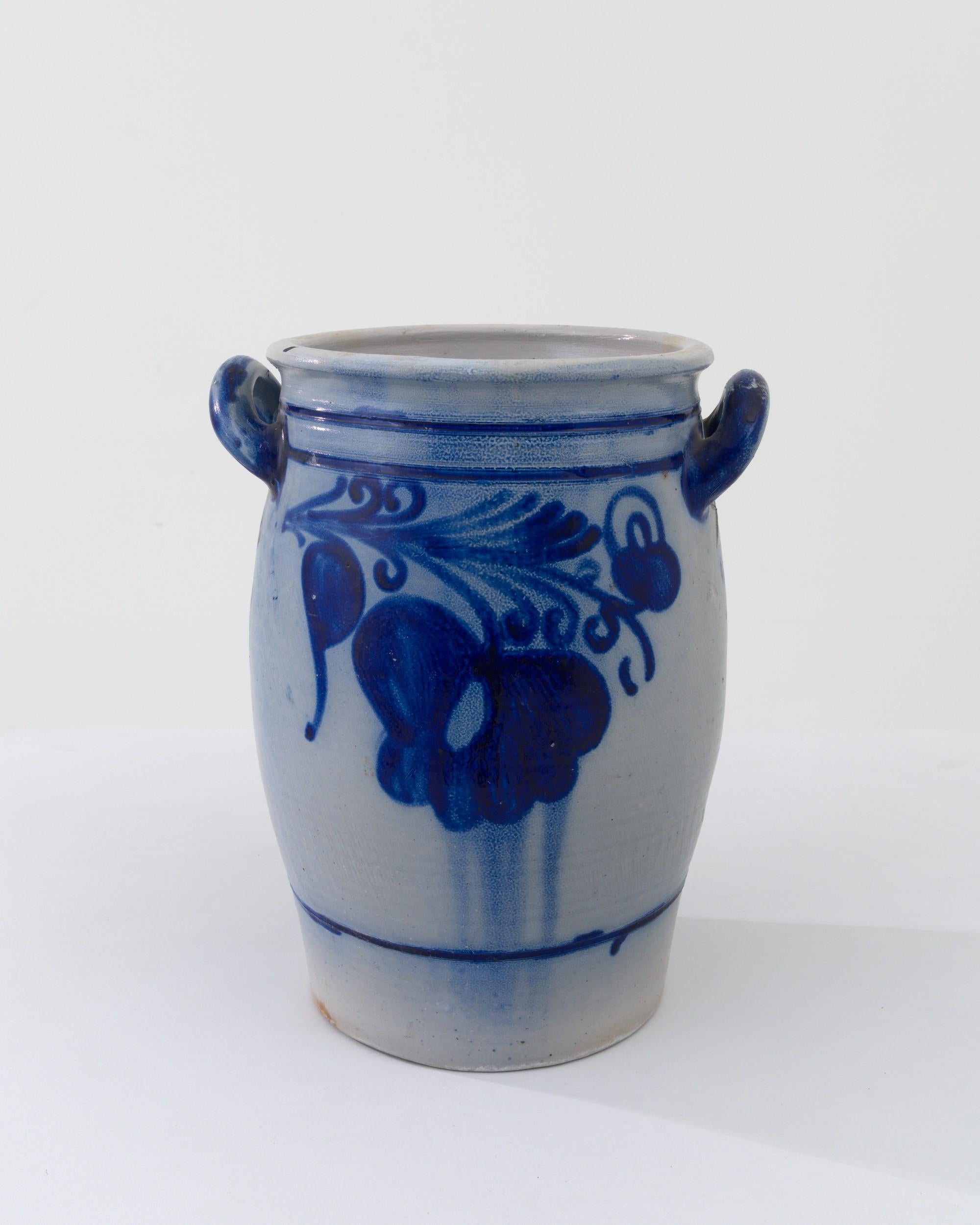 A typical country pot is finished with a distinctive vivid blue salt glaze, enhancing the rounded clay base with a charming nature inspired motif. The dominant form of storage for food or agricultural purposes for thousands of years, this ceramic