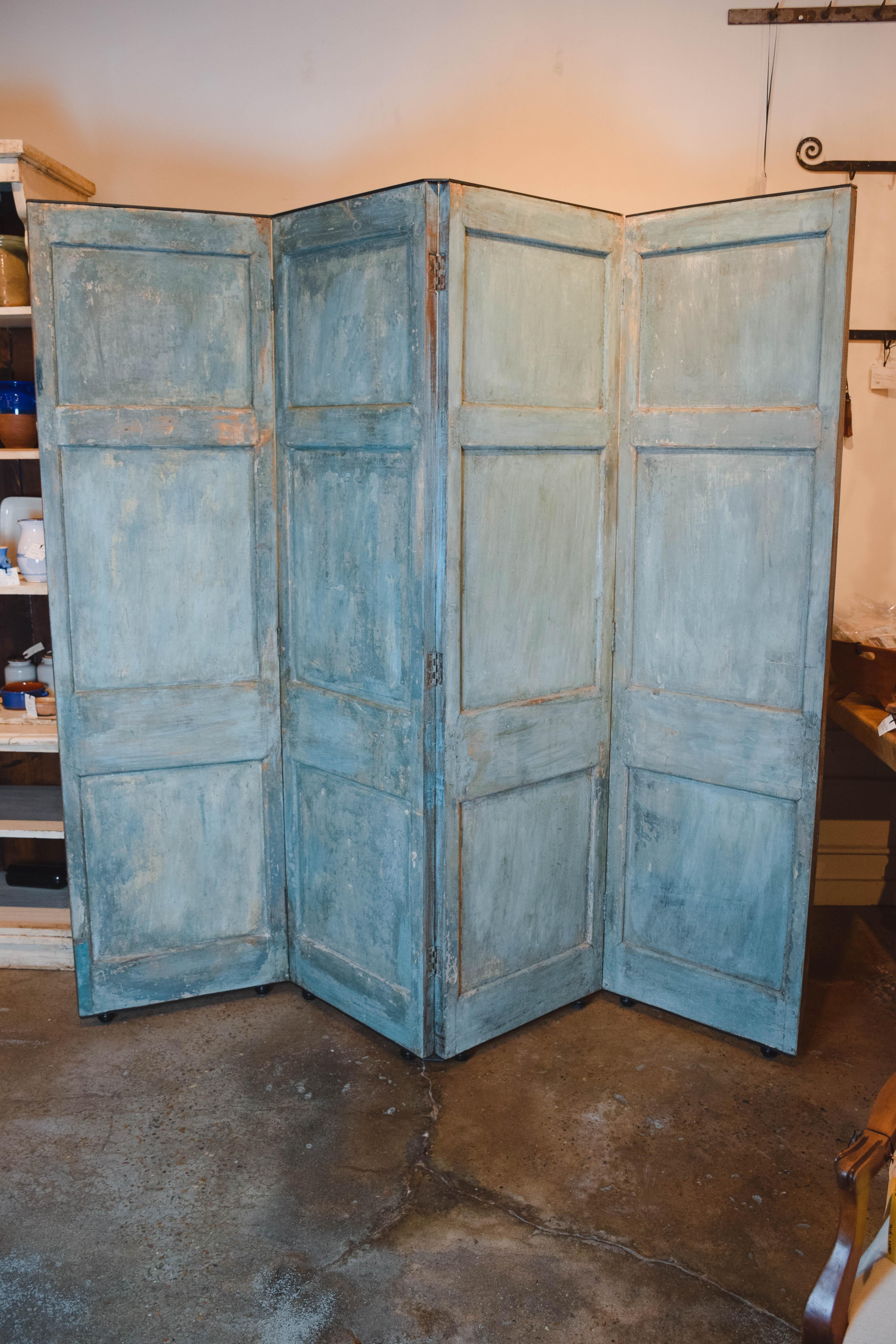 This is a beautiful antique Belgian screen on iron casters. Presented as found, we love the color, a great addition to any home. The screen features four 23.25 inch wide x 84 inch high x 1.5 inch deep panels hinged together. Dimensions below are for