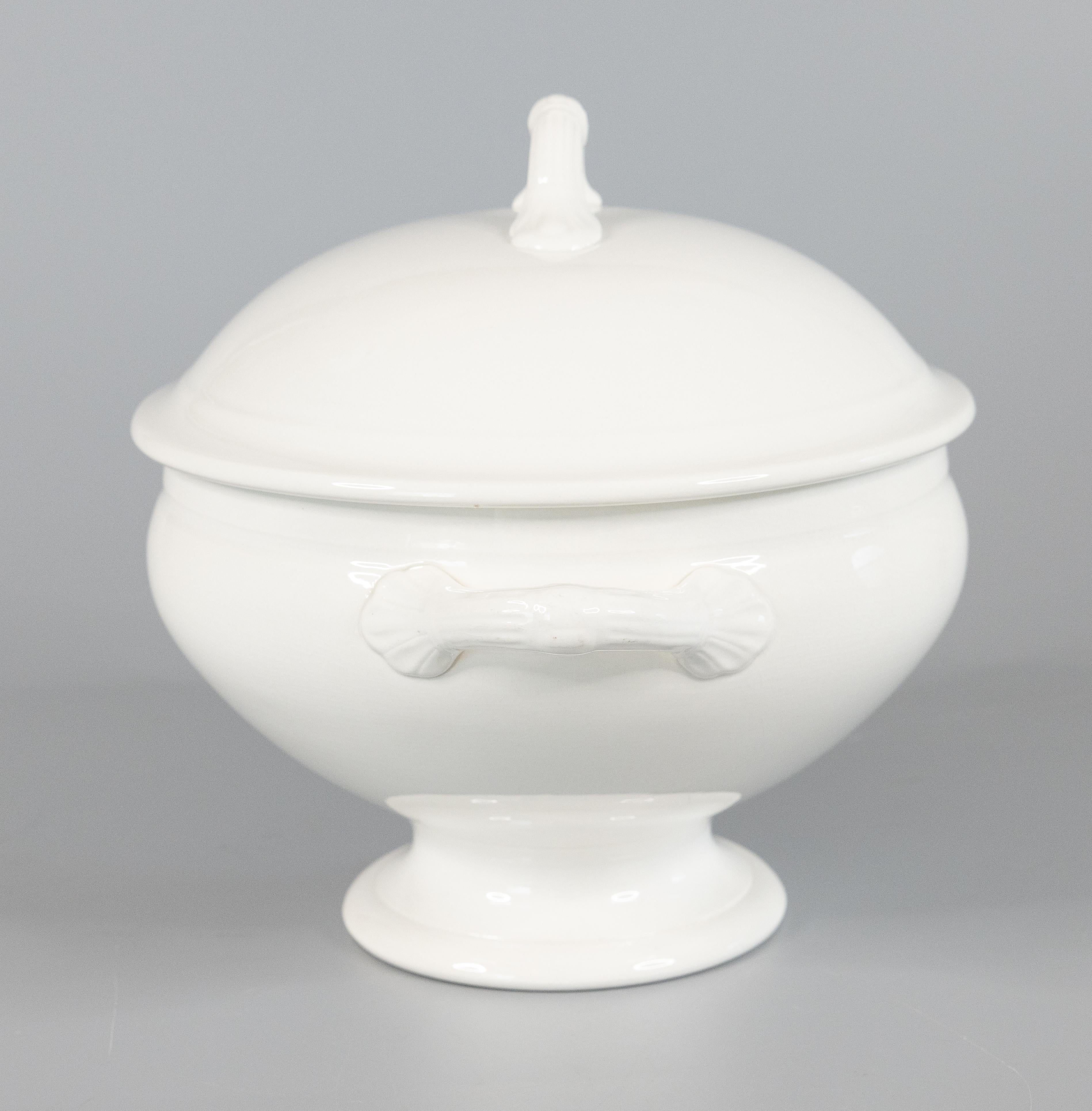 A gorgeous antique Belgian white ironstone lidded soup tureen made in Nimy, Belgium circa 1900. Maker's mark on reverse. This fine soup tureen has simple clean lines, perfect for the modern home, and would be lovely for display or serving at your