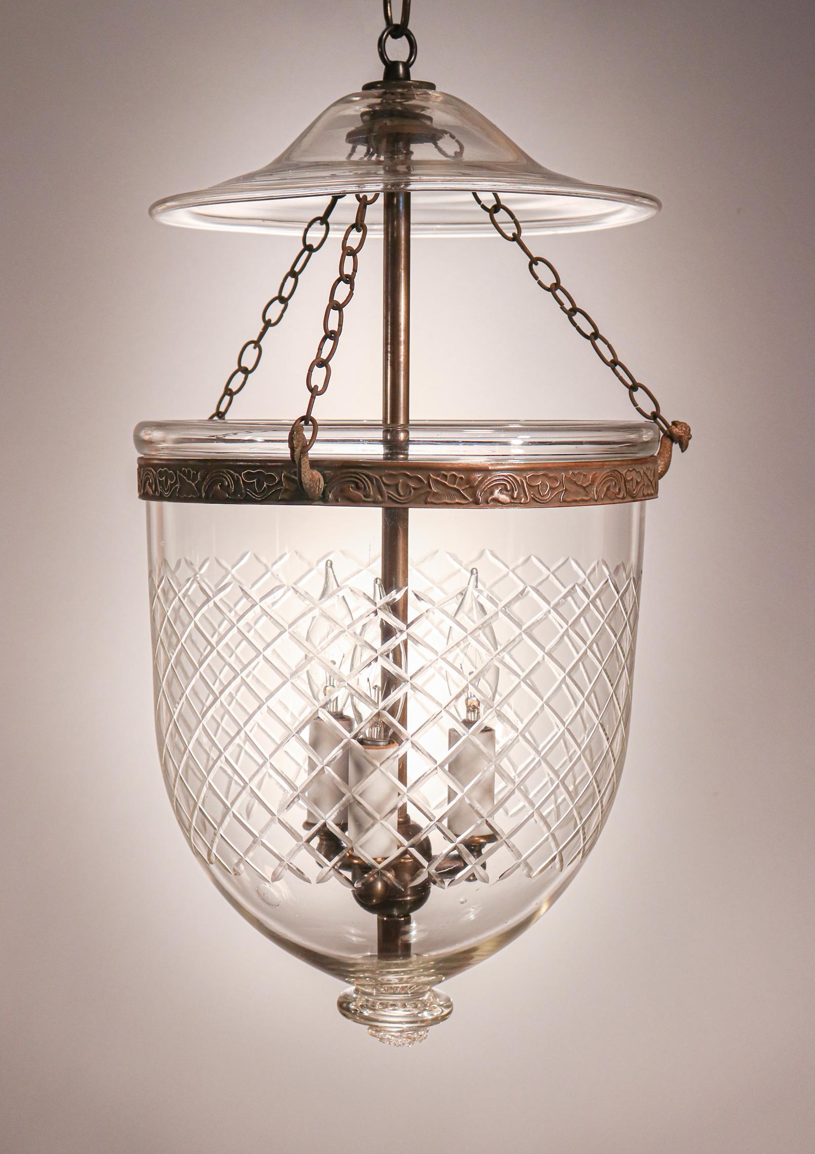 This circa 1890 English bell jar lantern features excellent quality handblown glass and pleasing form, both enhanced by a finely etched with a Waterford-style cut diamond motif. The lantern has retained its original smoke bell/lid and strands of