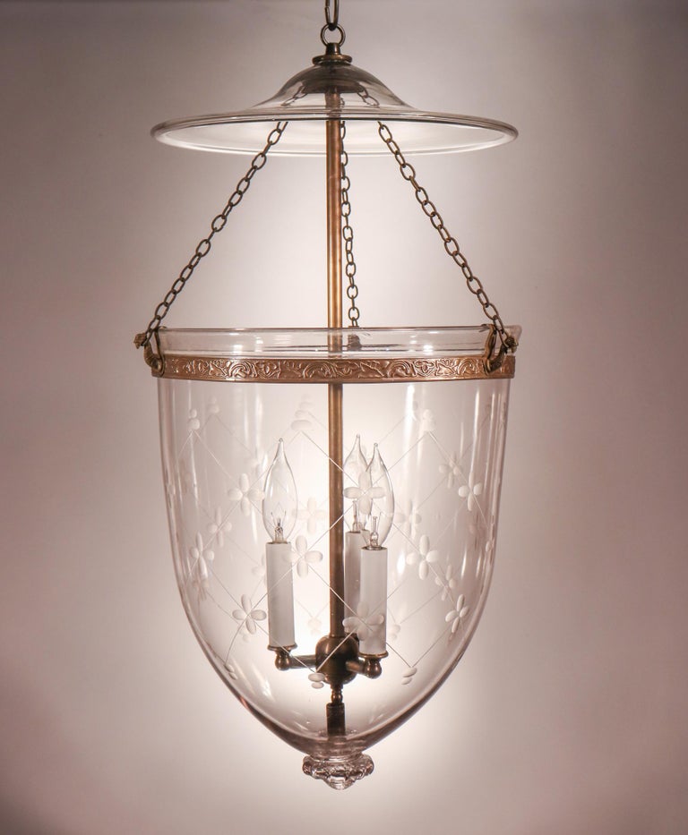 An exceptional, larger-sized English bell jar lantern with etched trellis motif. This circa 1870 pendant features excellent quality hand blown glass that is finished with a fabulous pontil/candle holder base. The lantern's brass band, which has an
