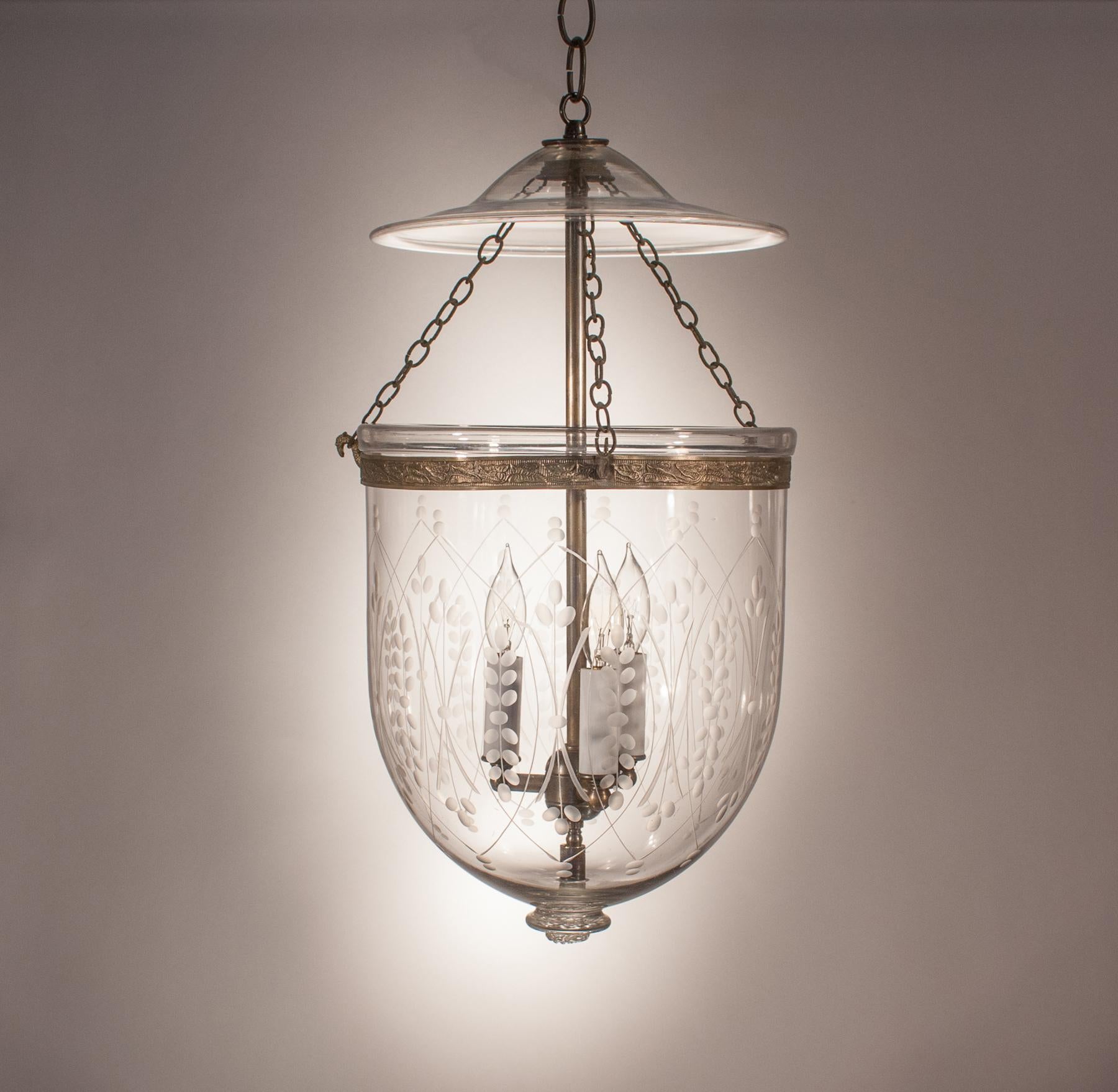 An authentic circa 1880 English hand blown glass bell jar lantern with its original brass band, chains and smoke bell/lid. This bell jar pendant has a lovely shape, which is complemented by a Classic, etched wheat pattern. The light has been newly