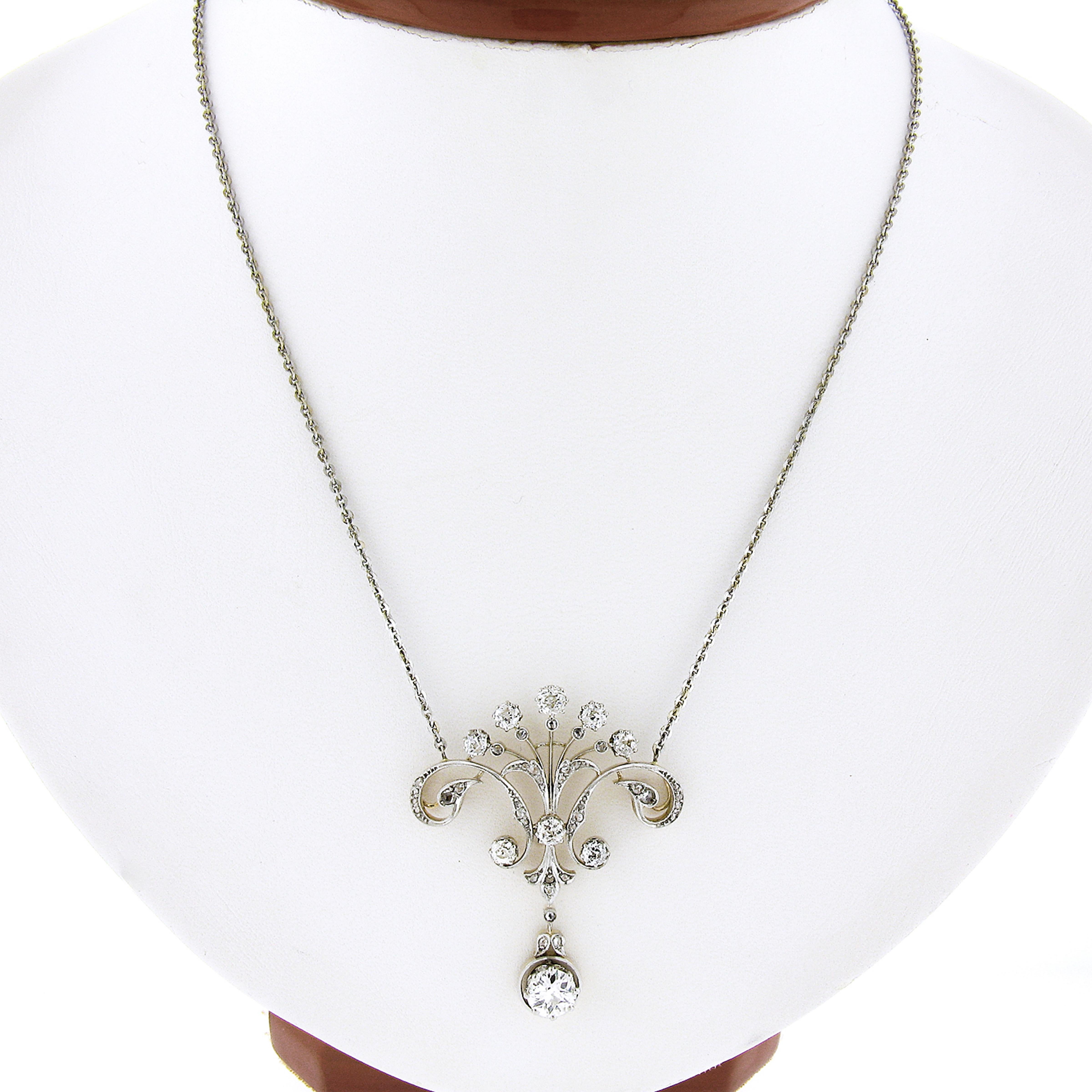You are looking at an absolutely magnificent and well made antique pendant that was crafted during the belle époque period from solid 14k yellow gold with a platinum top. This large lavalier pendant features an elegant open work design that is