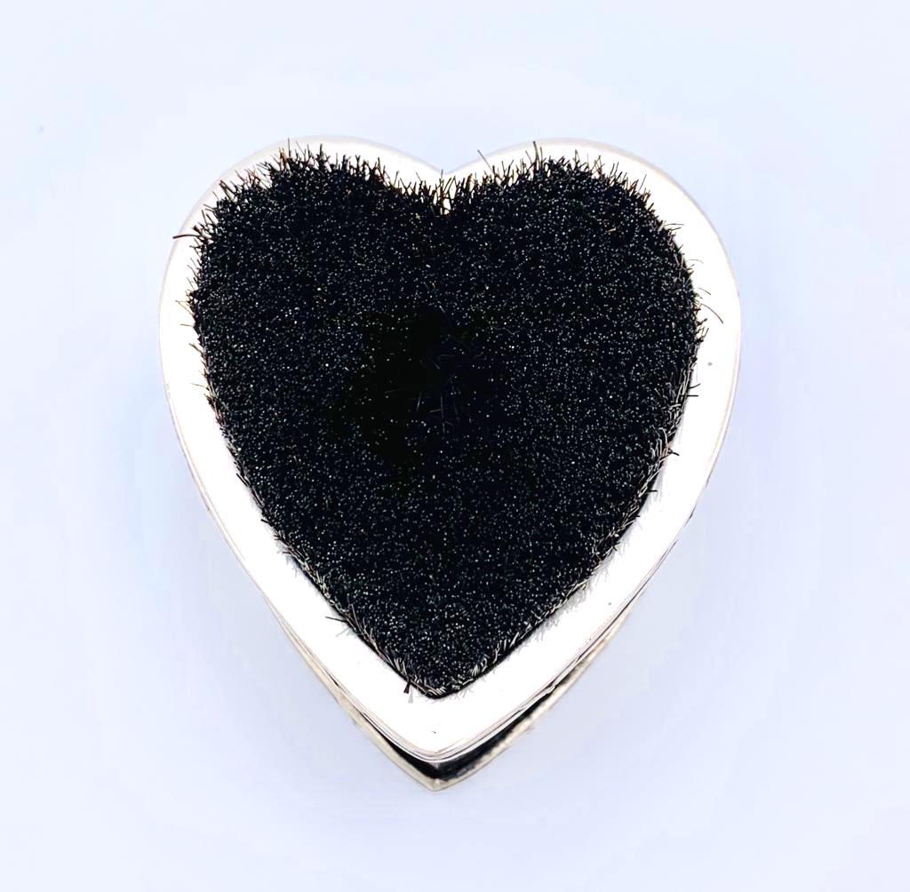 This unusual gentlemen's dress accessory in the shape of a heart is made out of sterling silver, celluloid and wood.
It was made by William Comyn's and son in 1906. The brothers Charles Harling Comyns and Richard Harling Comyns joined their father