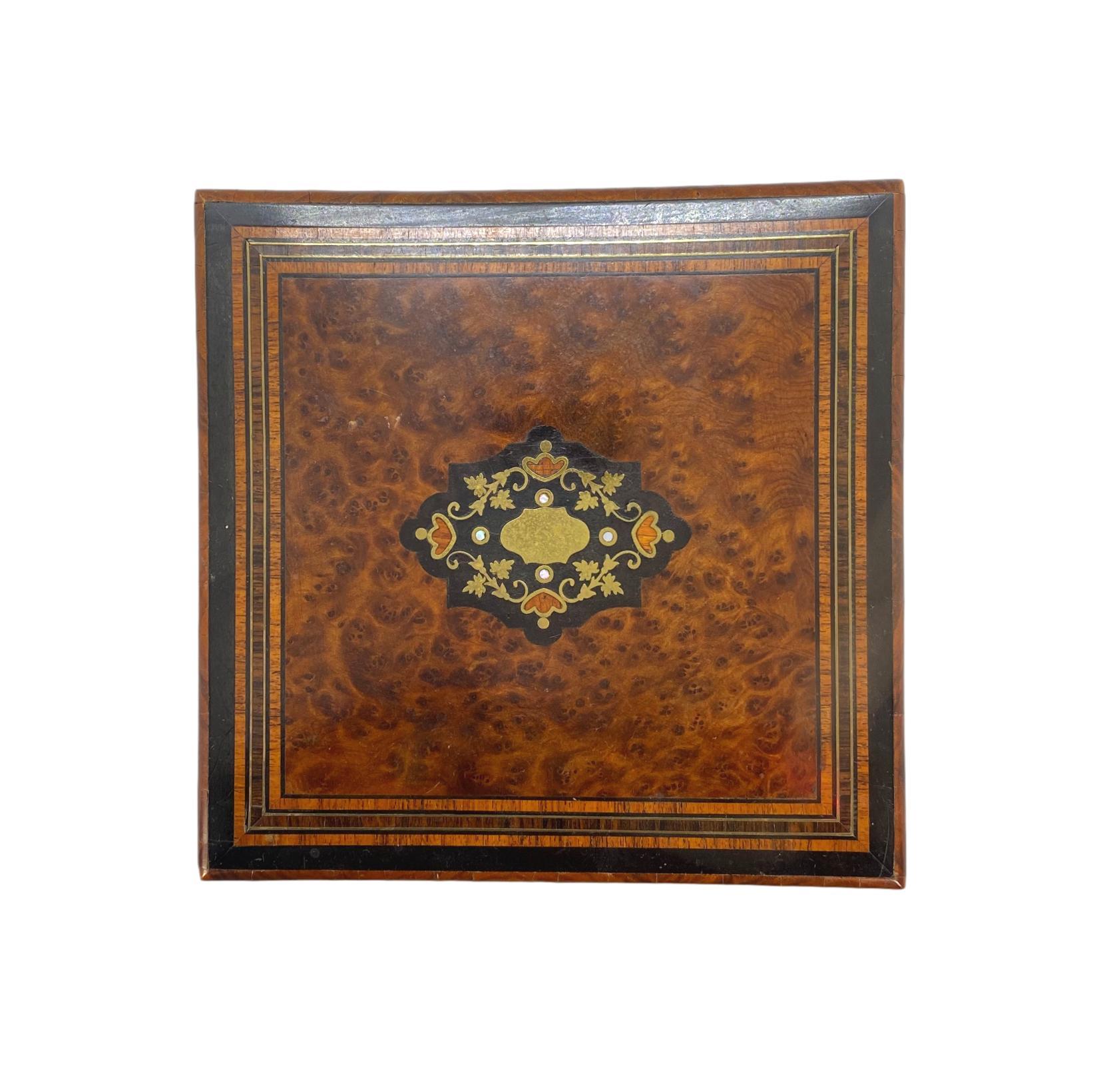 Belle Époque burl walnut box with intricately inlaid brass, ebony, and exotic woods, French, circa 1880. The highly figured burl walnut top chosen to resemble tortoise-shell.

  