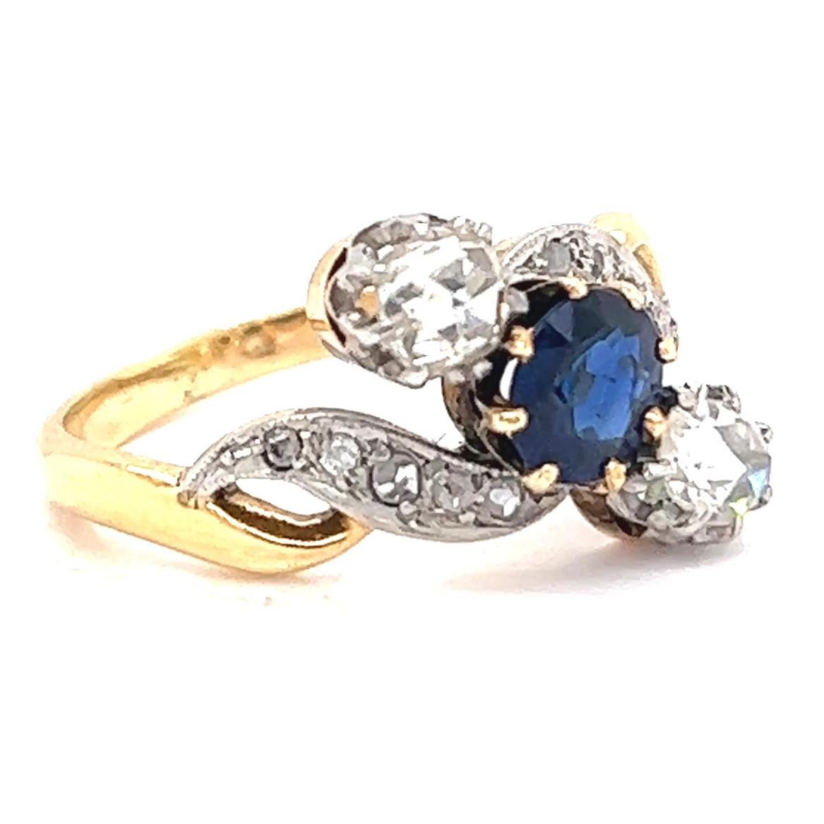 One Antique Belle Èpoque Diamond Sapphire 18 Karat Gold Platinum Ring. Featuring one oval shaped sapphire of approximately 0.80 carat, and two rose cut diamonds with a total weight of approximately 0.40 carat, graded G-H color, SI clarity. Accented