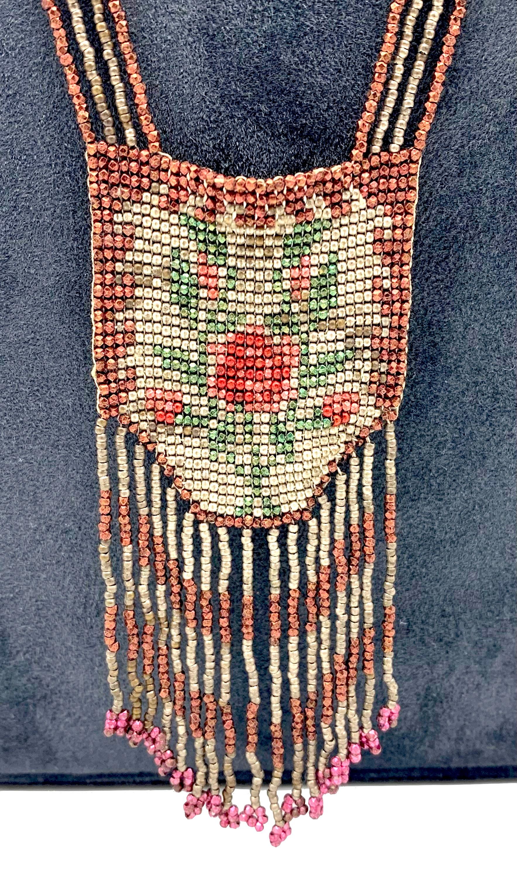 This exceptional beaded necklace has been handcrafted around 1910and is  made from polychrome coloured facetted metal beads and features a flower motif. Considering the delicacy and age of the beadwork it's condition is very good indeed.