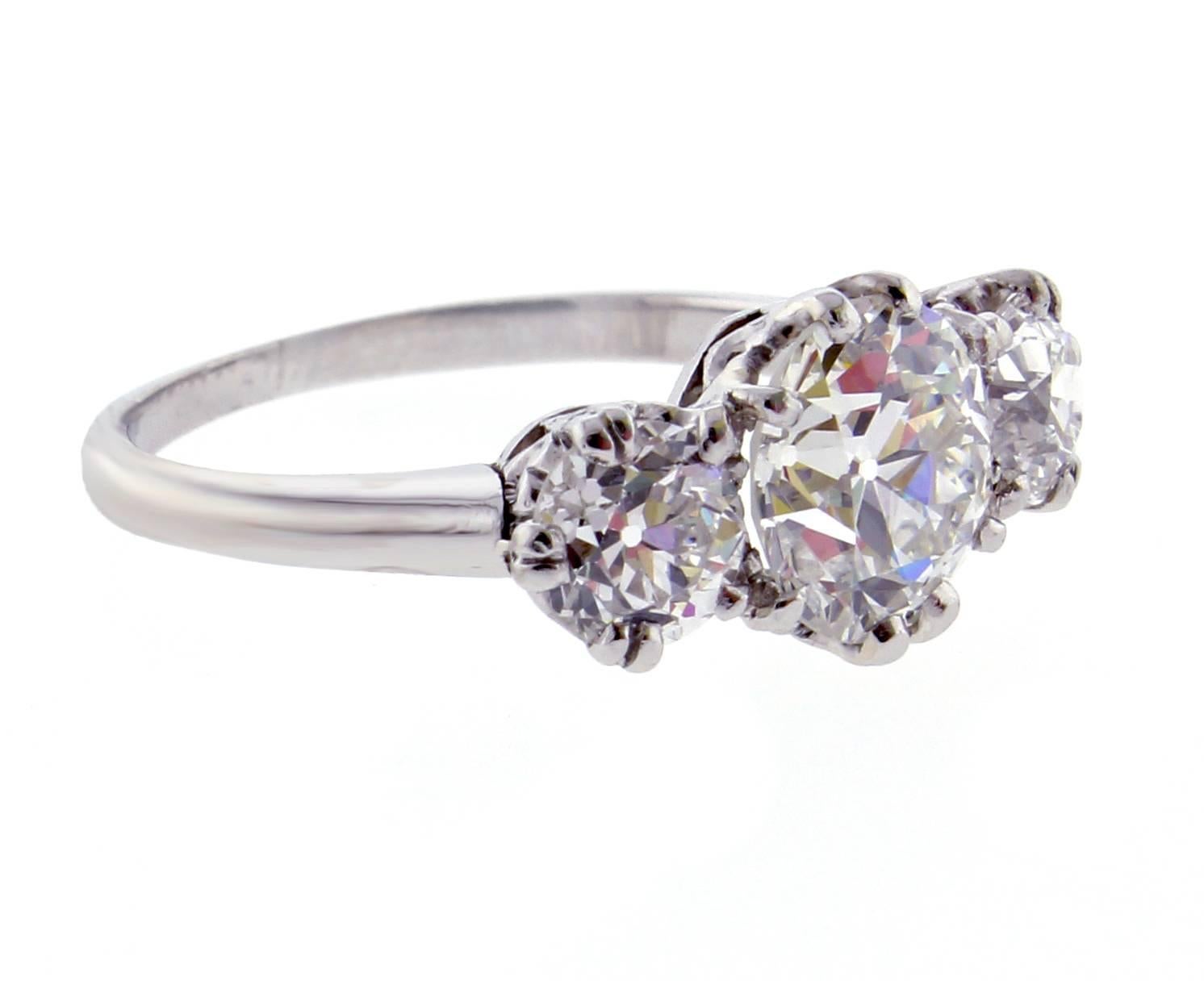 From the Belle Époque area this exception antique  platinum diamond ring. The ring feature a center old European cut diamond weighing 1.49 carats. G.I.A report # 1192424524 states the diamond is  G color and VS2 clarity. The two matching side