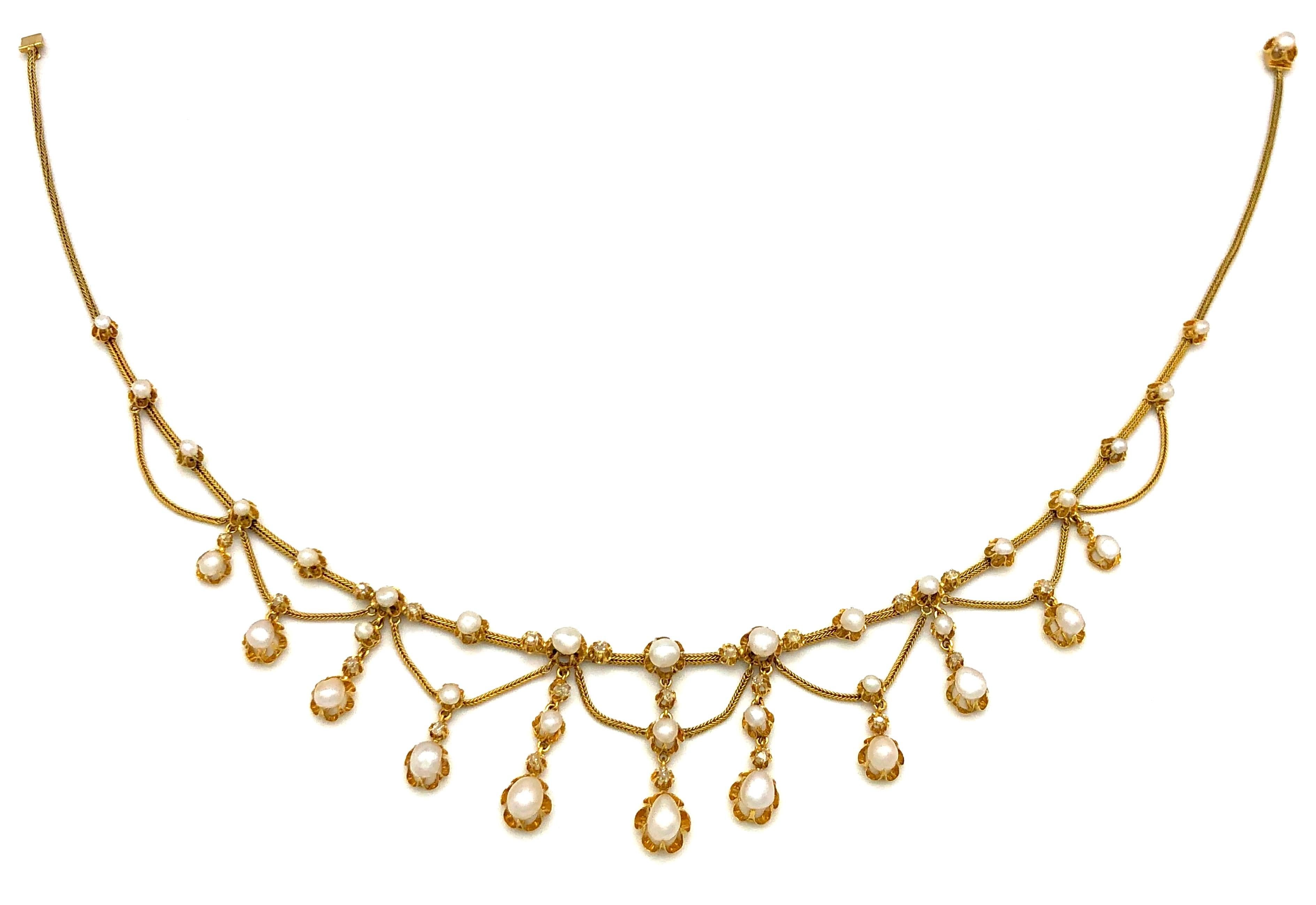 This  elegant Belle Époque necklace is composed of collet set oriental pearls and rose cut diamonds connected by foxtail gold chains.
The clasp is hallmarked with French assay marks, the eagle's heads. 
The top row is set with 17 pearls, the eleven