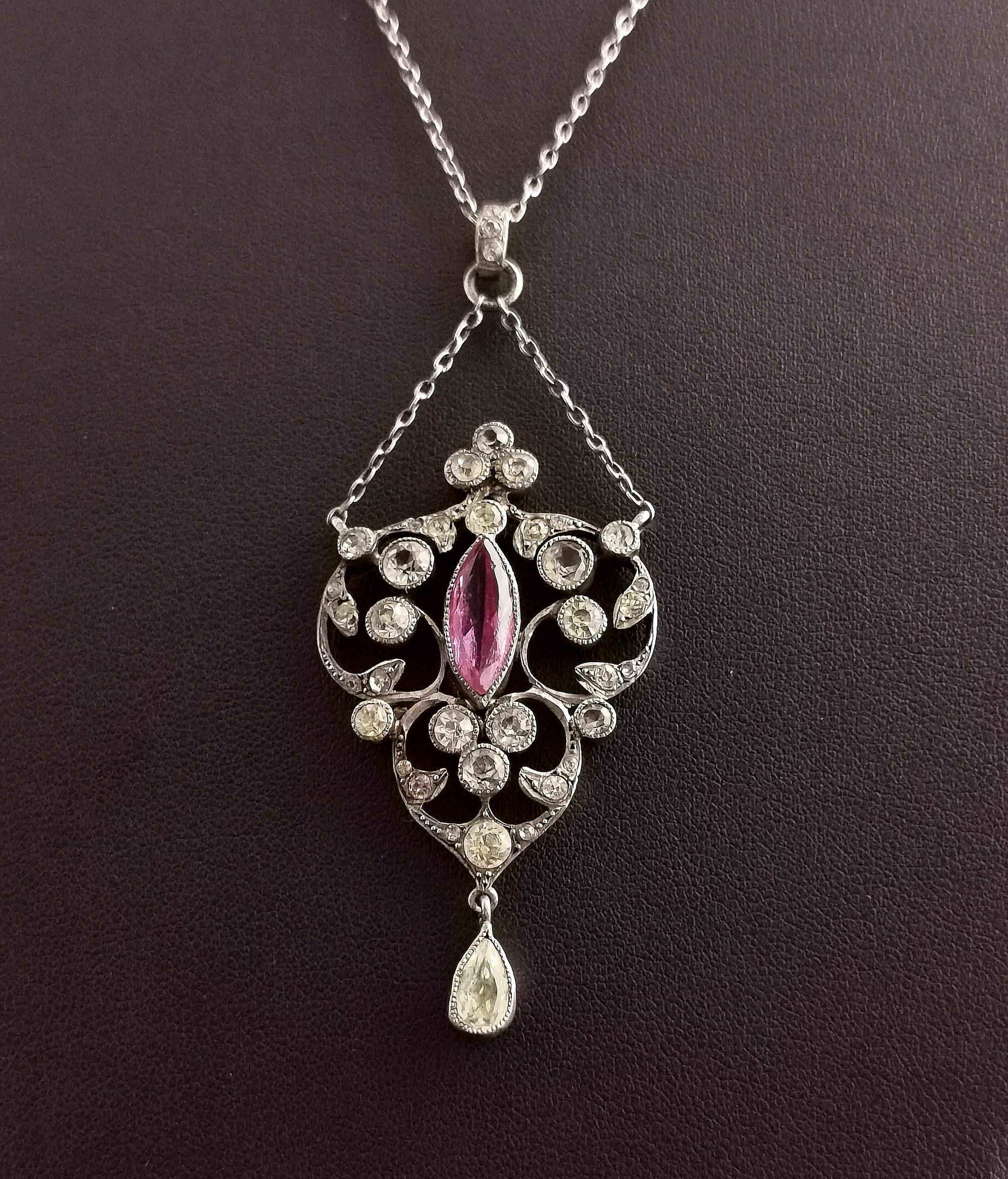 A stunning Antique Edwardian era, Belle Epoque sterling silver paste pendant necklace.

It has a large pretty lavalier style pendant drop suspended from a small length of chain set with old diamond paste stones and a single Amethyst paste, the