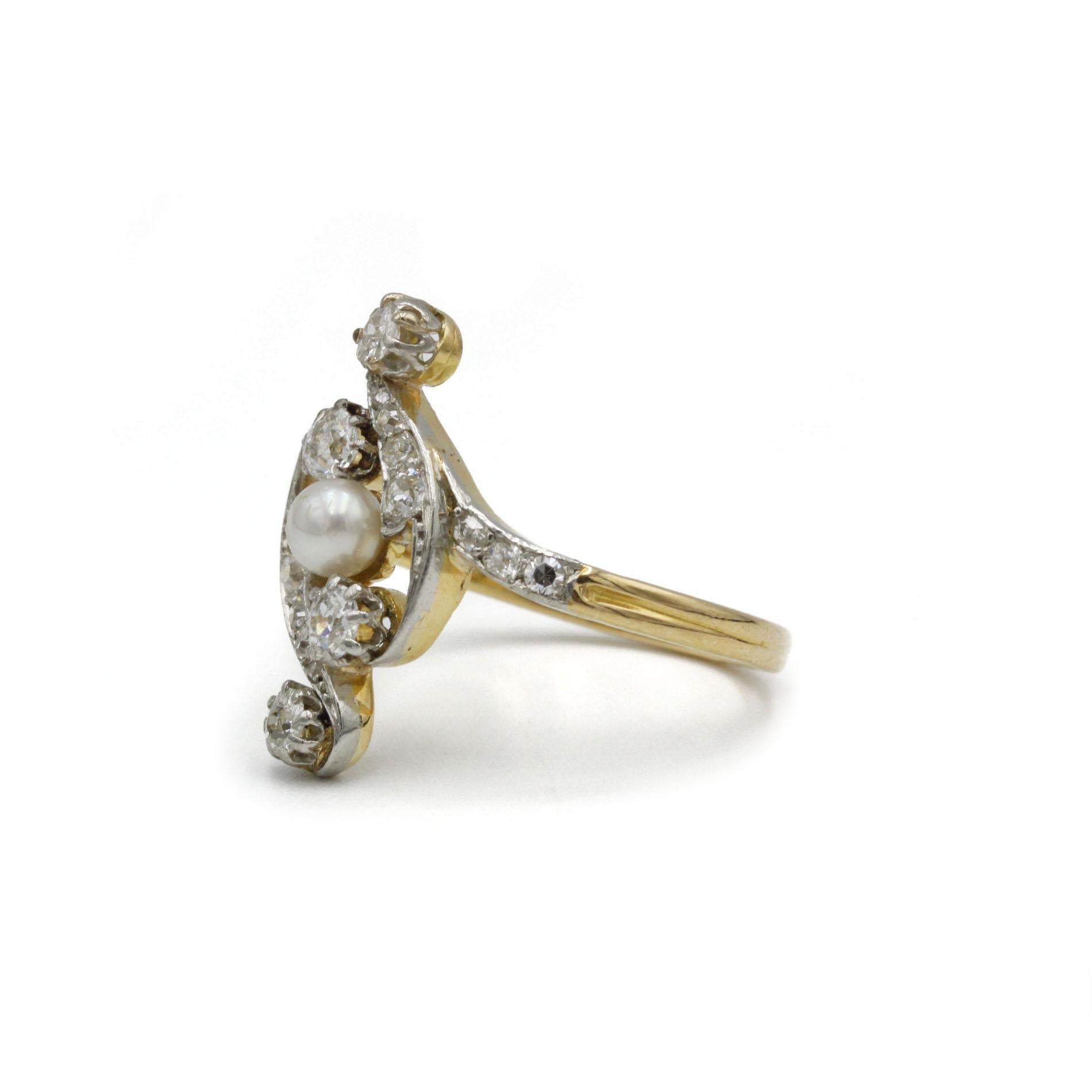 This exquisite antique ring from the Belle Époque period captures the romance and elegance of early 20th-century design. Masterfully crafted in 18K yellow gold, it features a delicate, flowing openwork design that gracefully wraps around a central