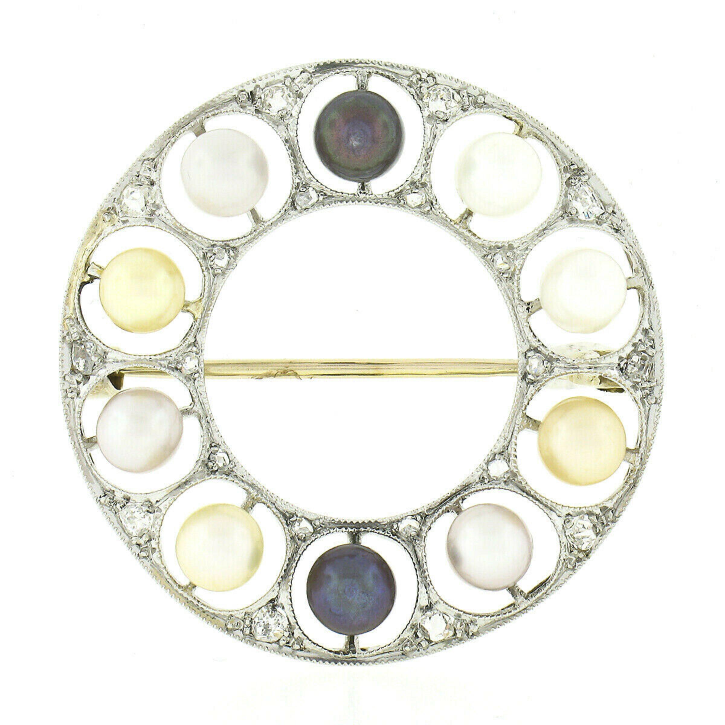 This beautiful antique pin brooch was crafted from solid platinum with a solid 14k yellow gold pin backing and features a circle wreath design that is adorned with fine pearls and diamonds throughout. The gorgeous pearls are well matched in size and