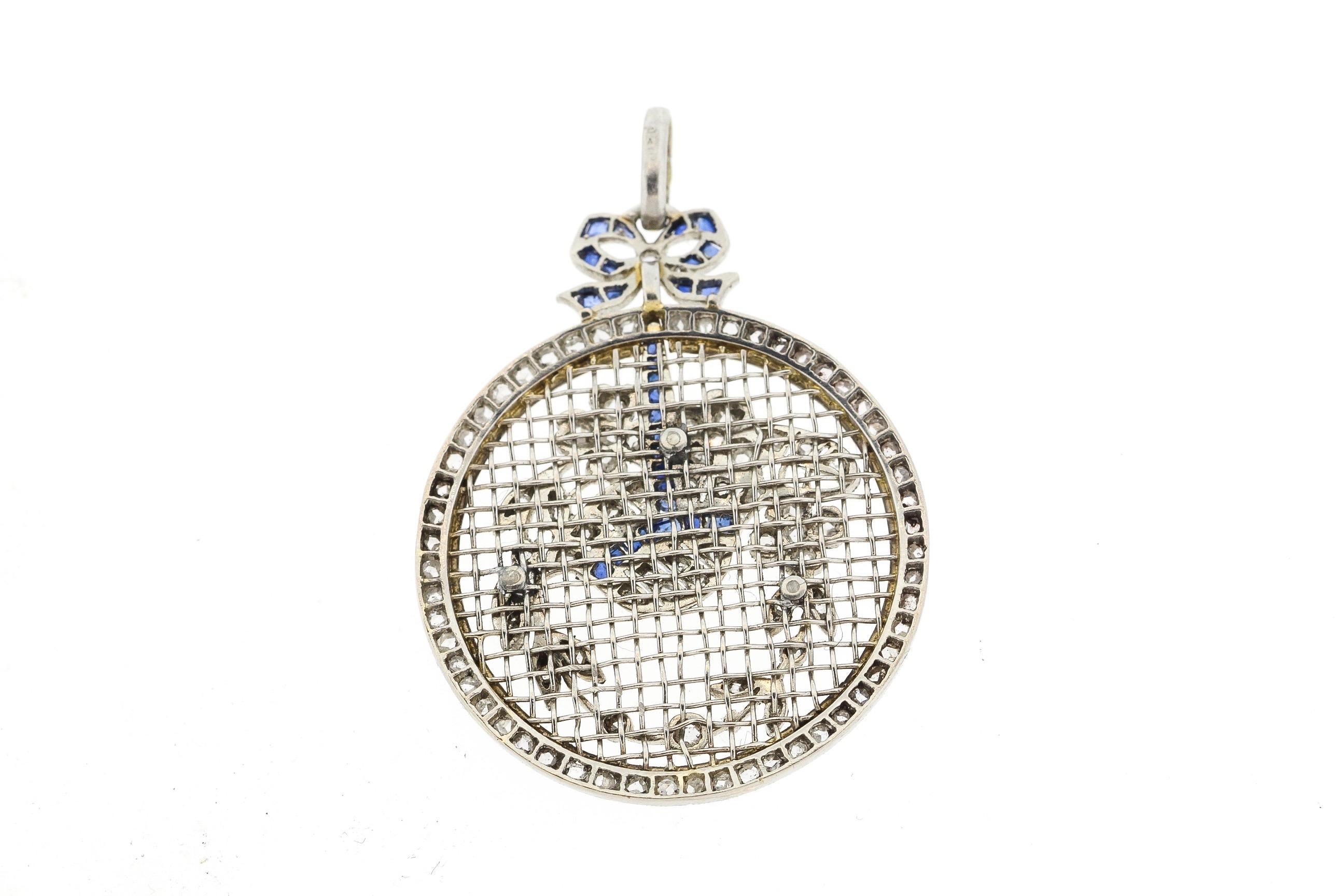 An antique rosecut diamond sapphire floral pendant exquisitely made by hand with platinum to resemble a framed needle point. This pendant is an excellent example of Edwardian aesthetic, which following the trend of the machinist jewelry of the end