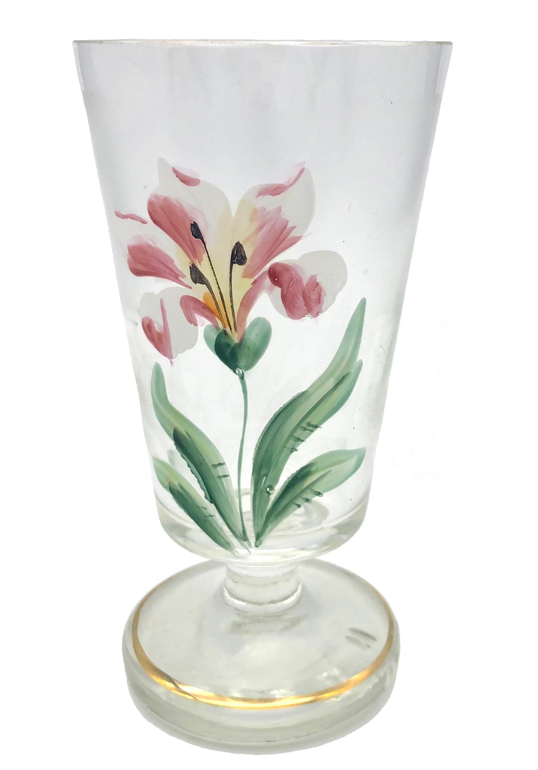 These four wine glases have been made in Bohemia in the last decade of the 19th century. 
They decoration is handpainted with lilies in full bloom on slightly irridescent clear glas, the foot of each glass is accentuated by a painted golden rim.