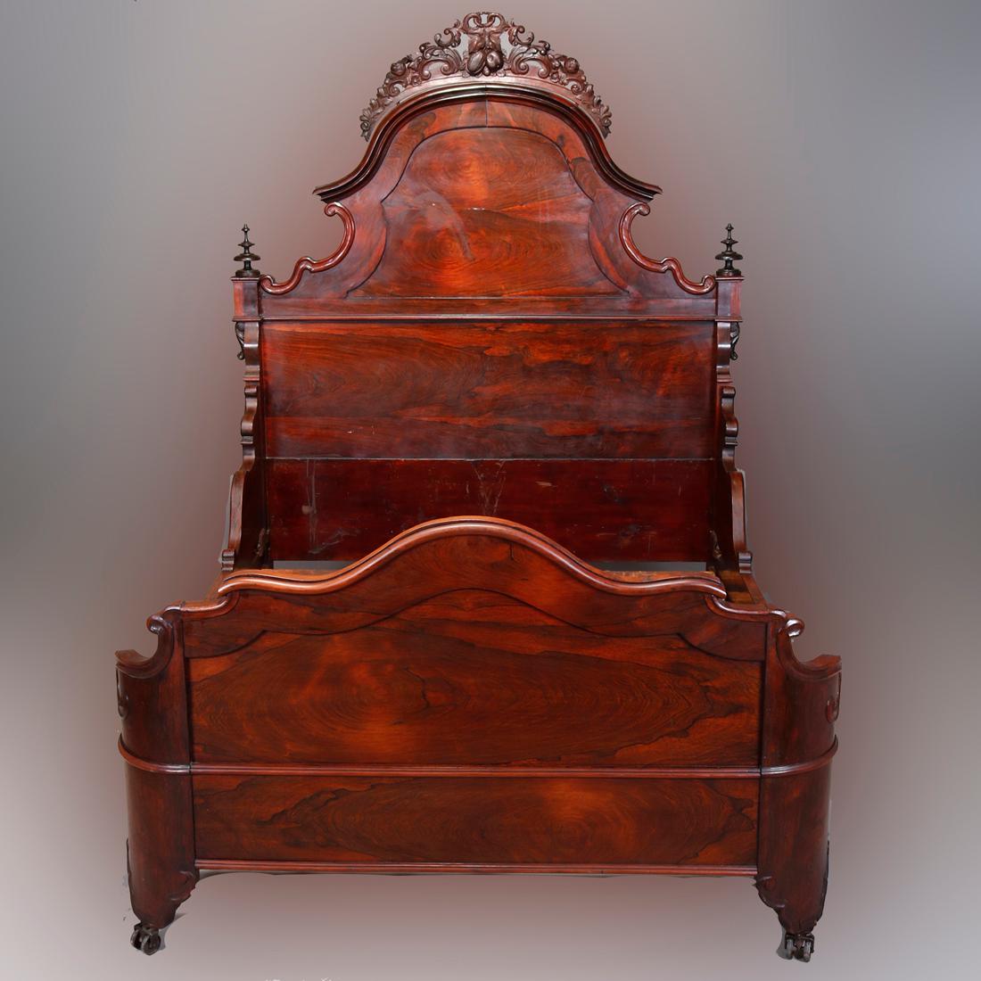 Antique full or double bed frame in the manner of John Henry Belter offers Rosewood construction with shaped headboard having pierced crest with scroll, foliate, fruit and nut carvings flanked by turned finials, 19th century

Measures: 84