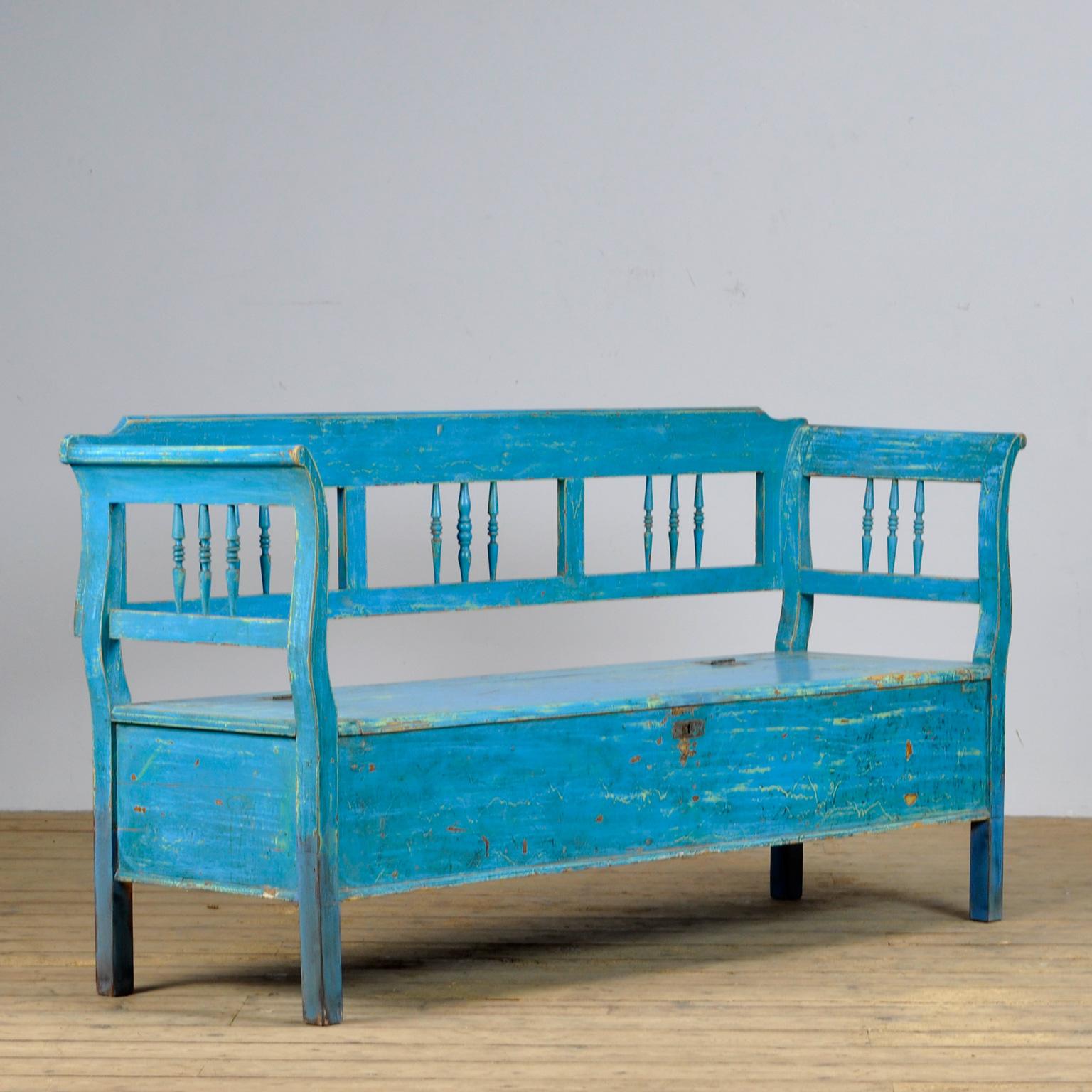 A charming bench from Hungary with the original paint. Over time and use, the blue paint has been worn away in places to the wood. With storage space under the seat. The bench is stable and sturdy. Free of woodworm.