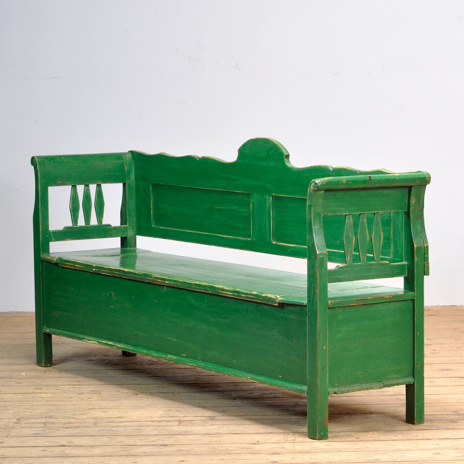 A charming bench from Hungary with the original paint. Over time and use, the green paint has been worn away in places to the wood. With storage space under the seat. The bench is stable and sturdy. Free of woodworm.
 