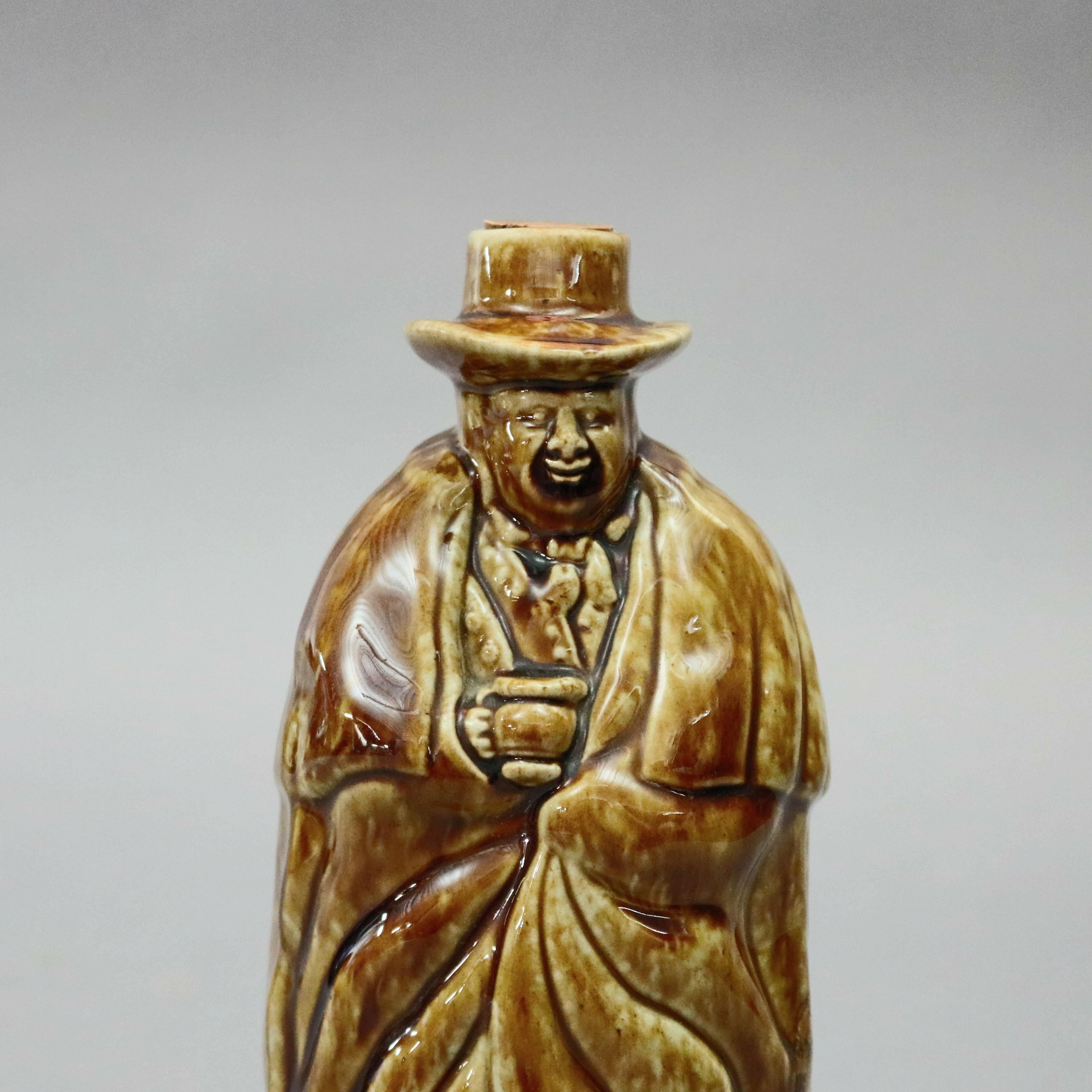 An antique Bennington Pottery figural whiskey flask offers coachman form in Rockingham glaze, maker stamp on base as photographed, circa 1849

Measures - 10