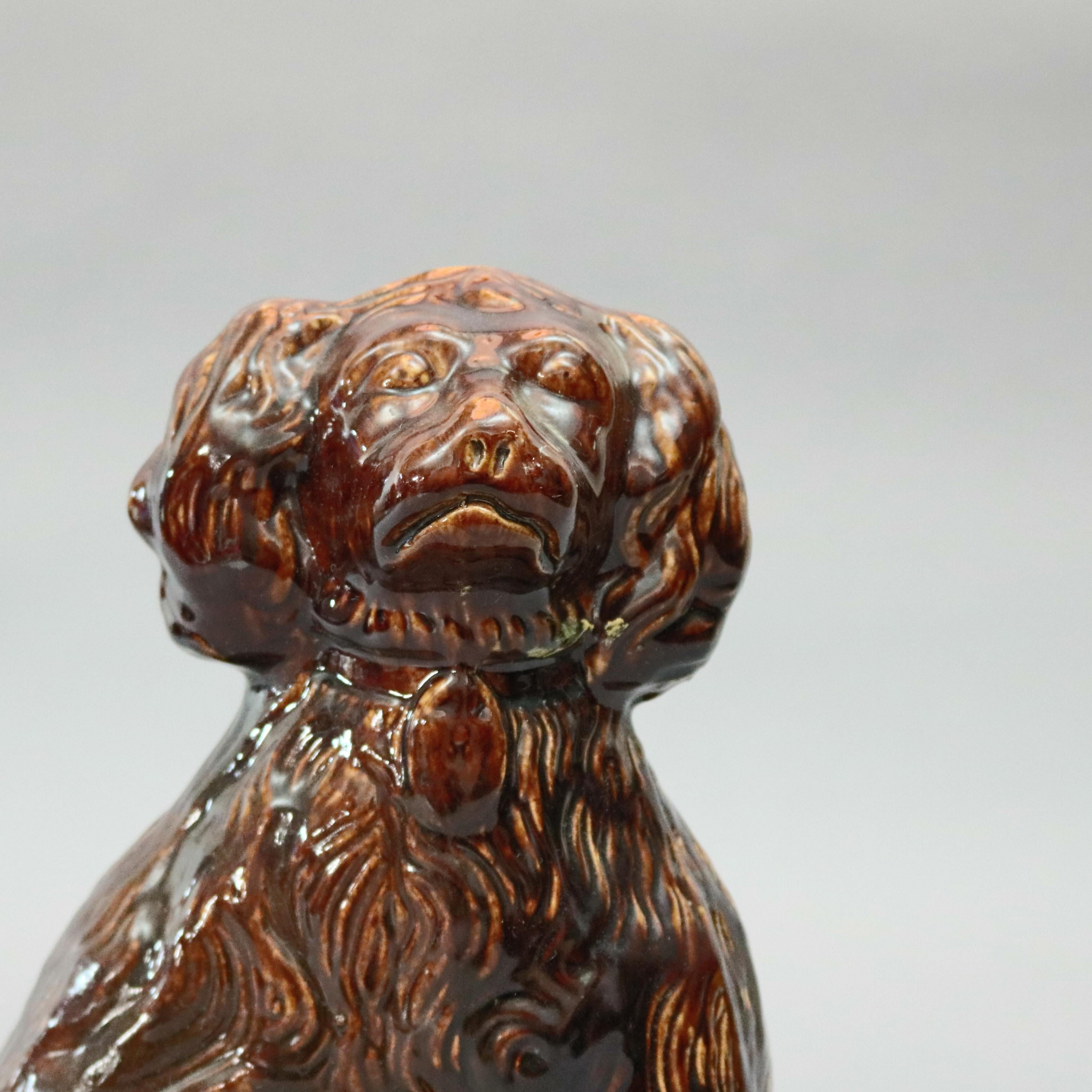 An antique Bennington Pottery School figural dog offers spaniel form in Rockingham glaze, circa 1849

Measures: 12.25