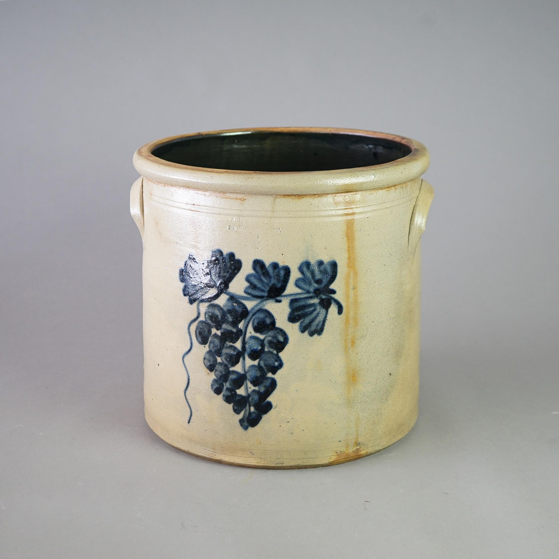 An antique Burlington crock offers salt glazed stoneware construction with double handles and blue decorated with wine grapes and leaf, maker stamped, c1870

Measures - 13.5