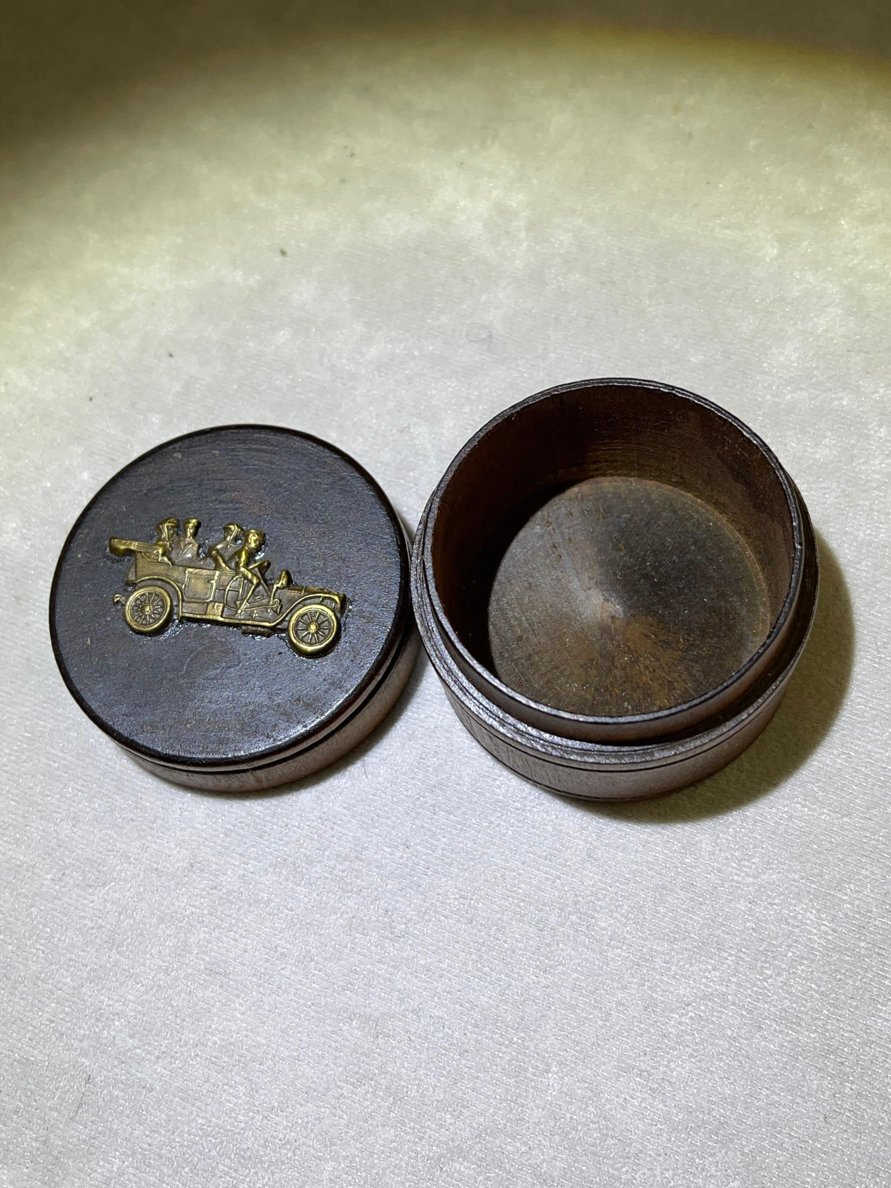 This cute little pill box has survived over 100 years. Intended to carry snuff, or pills if you wish, but primarily to make you smile when you see that old car attached to the lid. The curved wood has remained entirely intact, and free of splitting