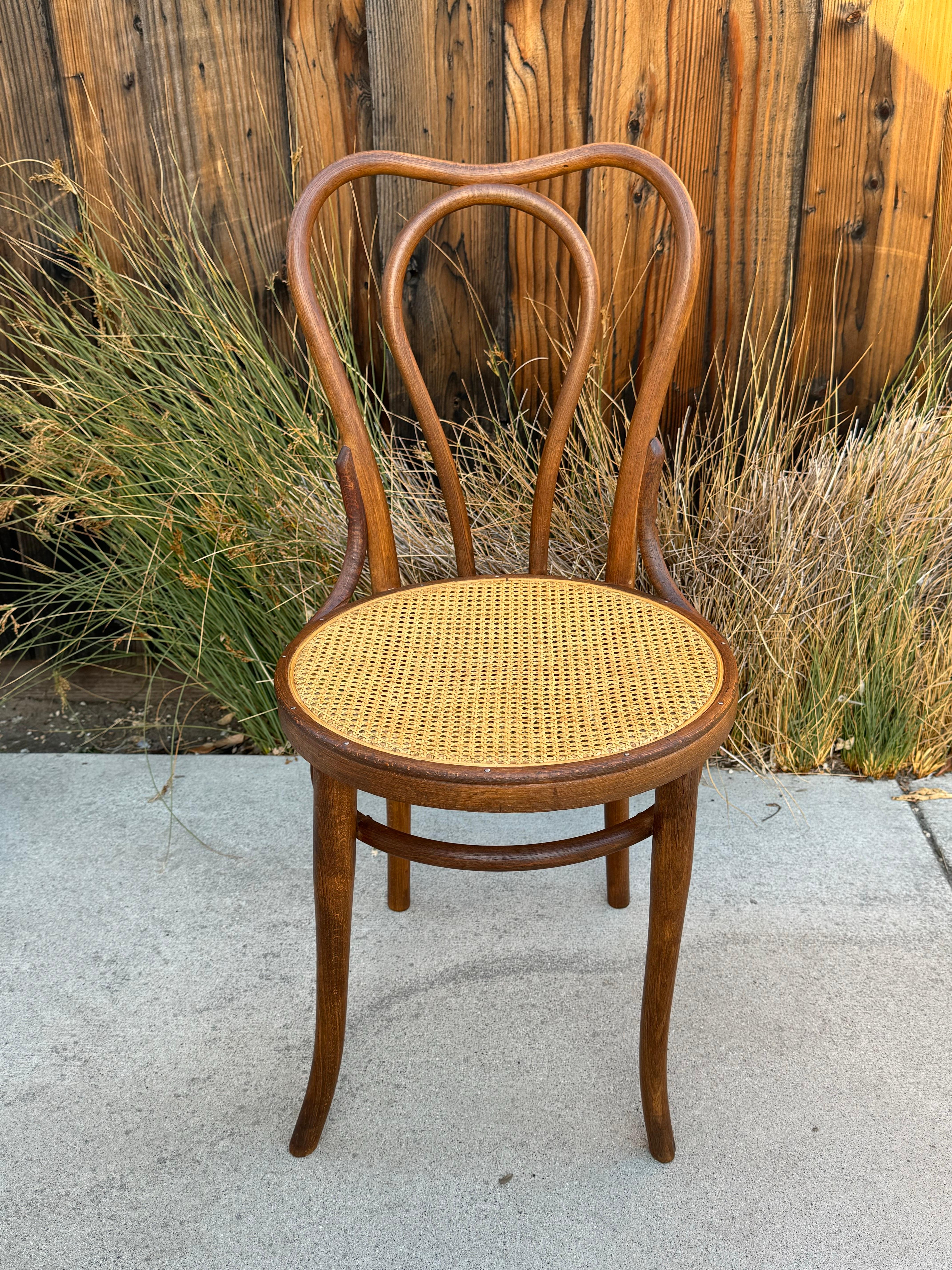 For Sale: Gorgeous Antique Thonet Bentwood Chair with Cane Seating

Add a touch of timeless elegance to your space with this classic Thonet bentwood chair, produced in Austria. Perfect as a bistro or side chair, this antique piece showcases the