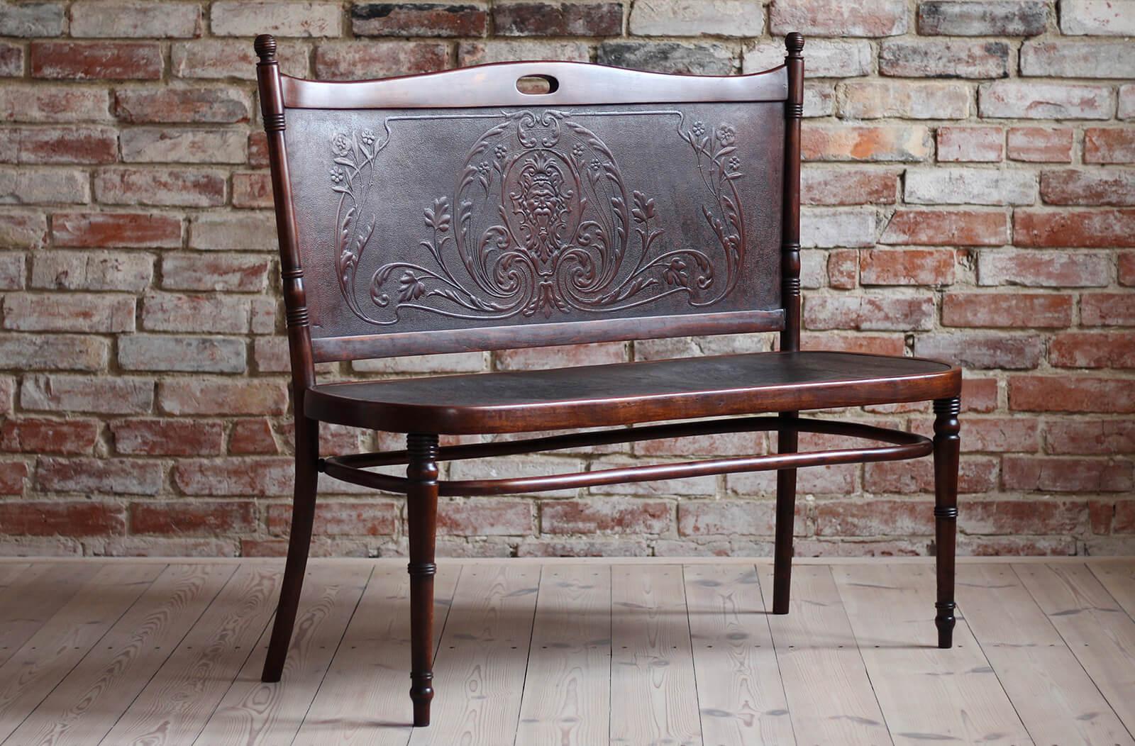 This exceptional bentwood bench settee was made in early 20th century and is attributed to Jacob & Josef Kohn. The bench features embossed plywood seat and back with characteristic bentwood wooden frame. There is no original label preserved however