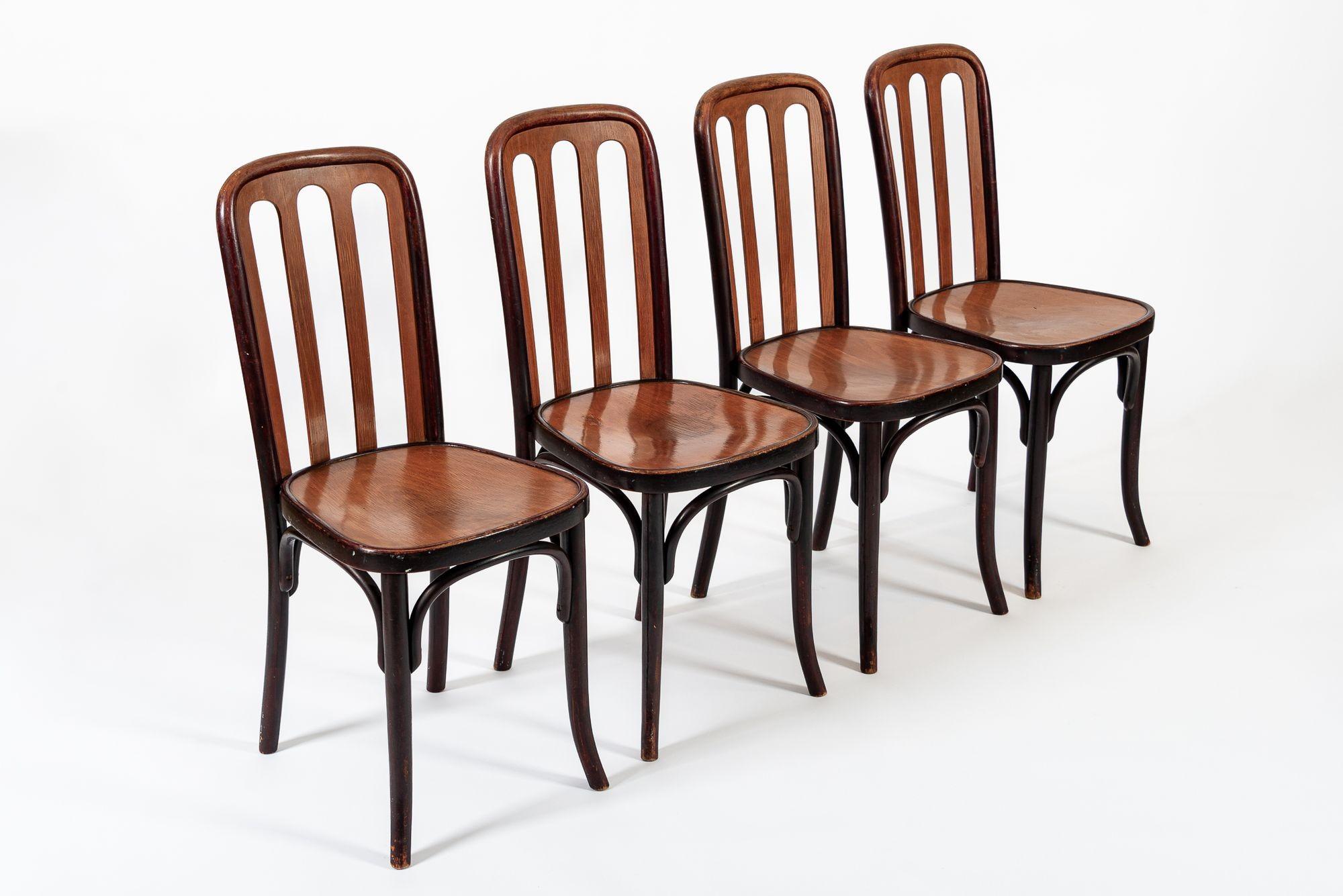 This set of four antique bentwood cafe chairs designed by Josef Hoffman and manufactured by Thonet are circa 1920. The iconic bentwood cafe bistro chair has a simple design with elegant curves using minimal pieces of wood - a hallmark of all