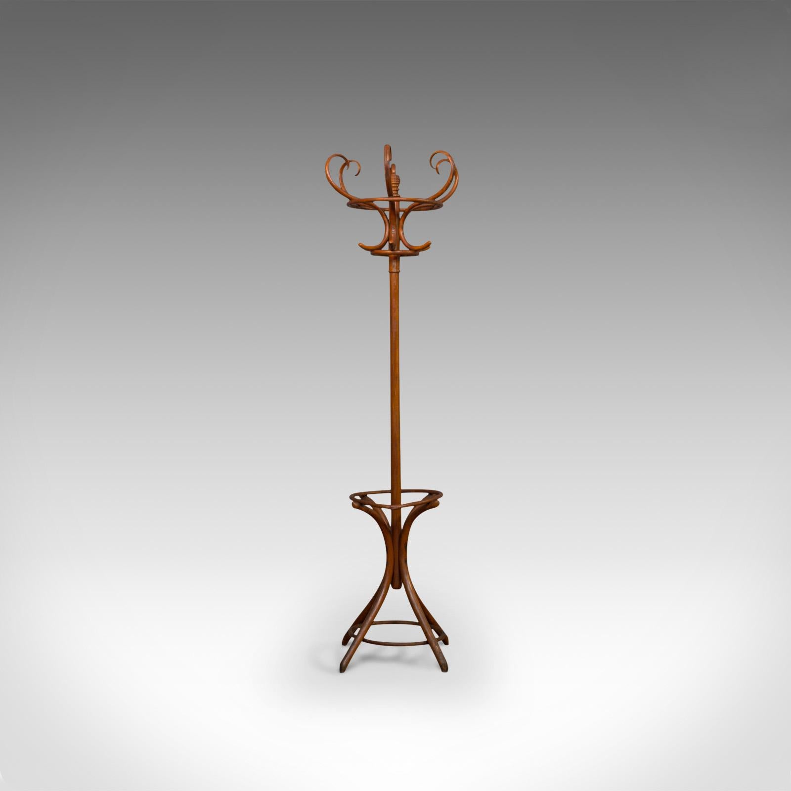 This is an antique bentwood coat rack or hall stand. An English, beech hat, coat, stick or umbrella stand, and dating to the Edwardian period, circa 1910.

Displays good color throughout and a desirable aged patina
Six sinuous 's' curved rails