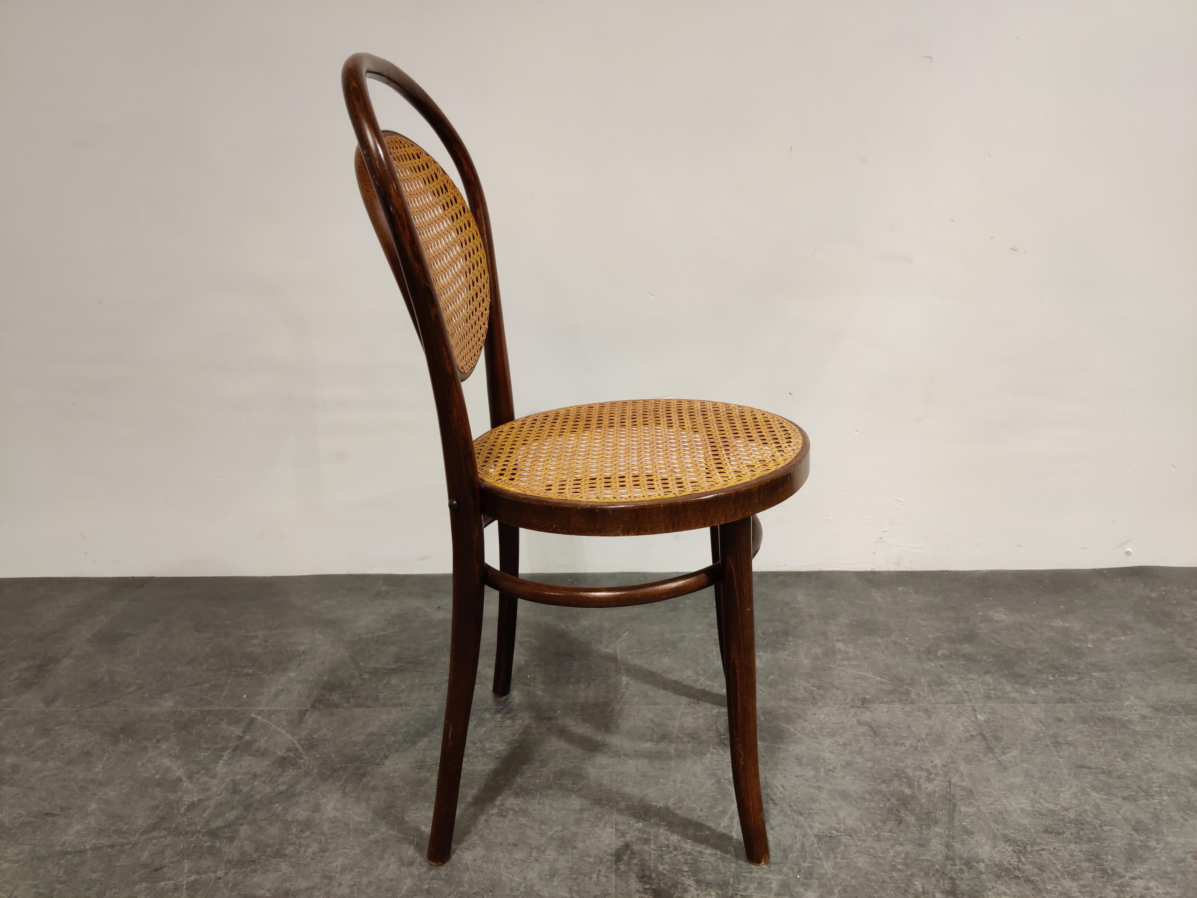 Dark brown bentwood dining chair.

Stamped 'made in Romania'. 

We date it at early 1950s.

Good condition

Dimensions:
Height 90cm/35