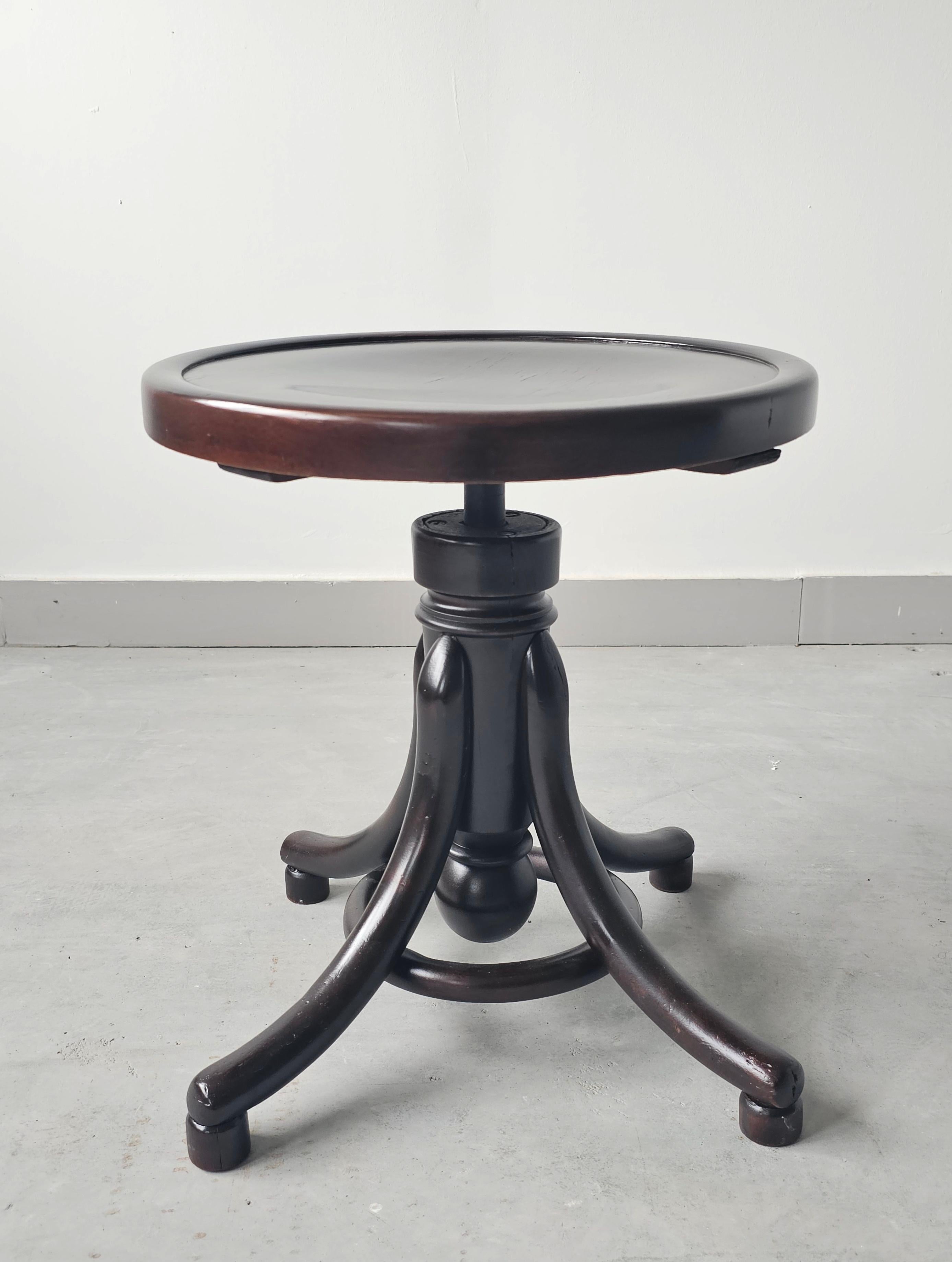 In this listing you will find an antique piano stool manufactured by Thonet. The stool is done in beech bentwood, with the plywood seat. It was recently refinished. The swivel mechanism is stuck, so there is no possibility to adjust its height. Made
