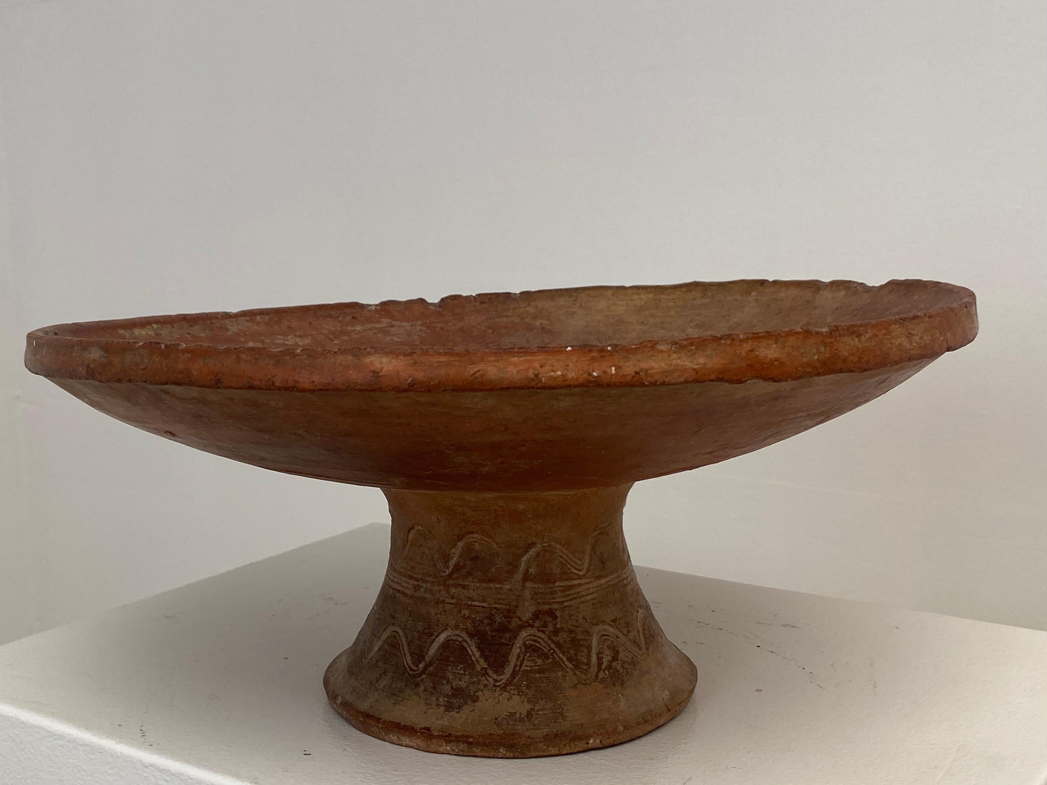 Elegant , Antique terracotta Bowl on a central foot,
Morocco from around 1920,
the Red Terracotta has a nice shine and antique patina,
decorated with elegant and fine lines,
very decorative object to be used for different purposes