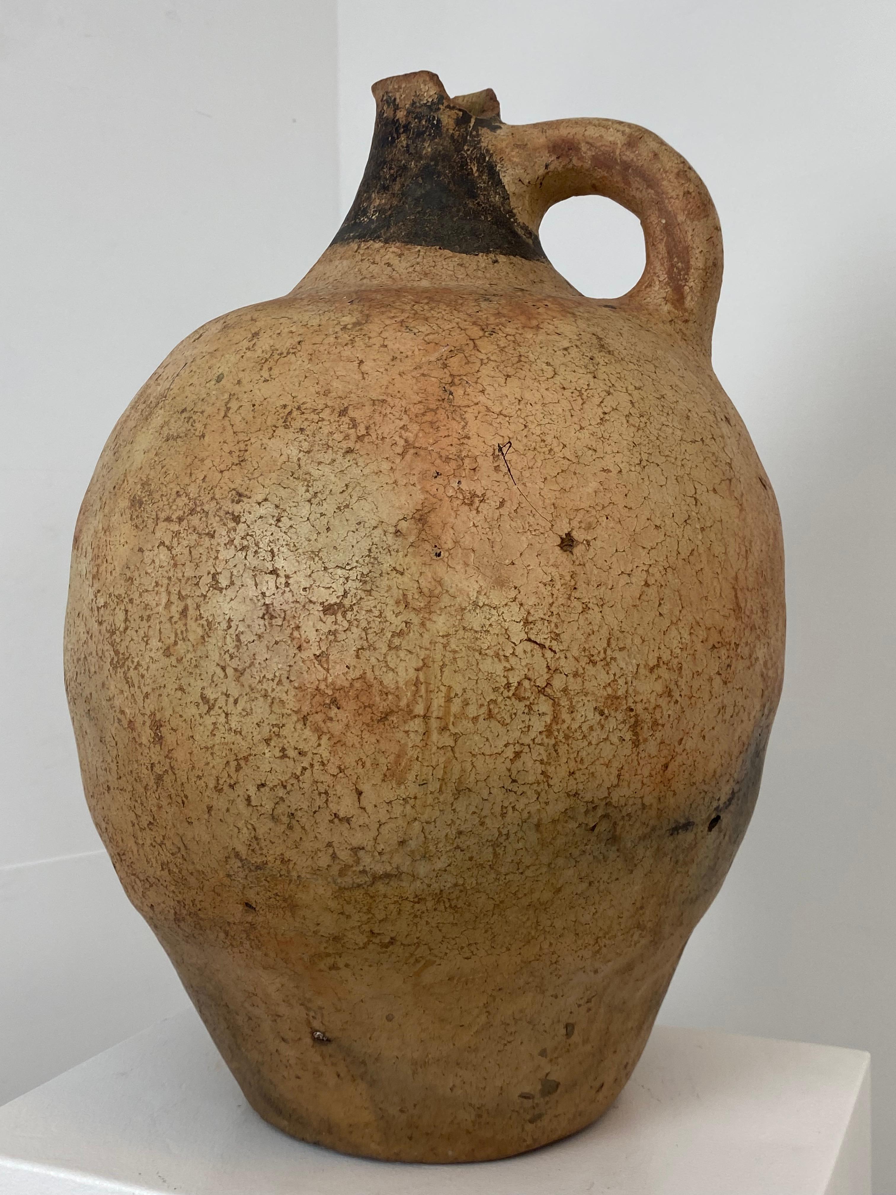 Antique Berber Terracotta jar from Southern Morocco from around 1920,
the jar has one handle and has a beautiful Patina and Shine and a Black colored top decoration,
great Brown-Beige Color, very decorative object