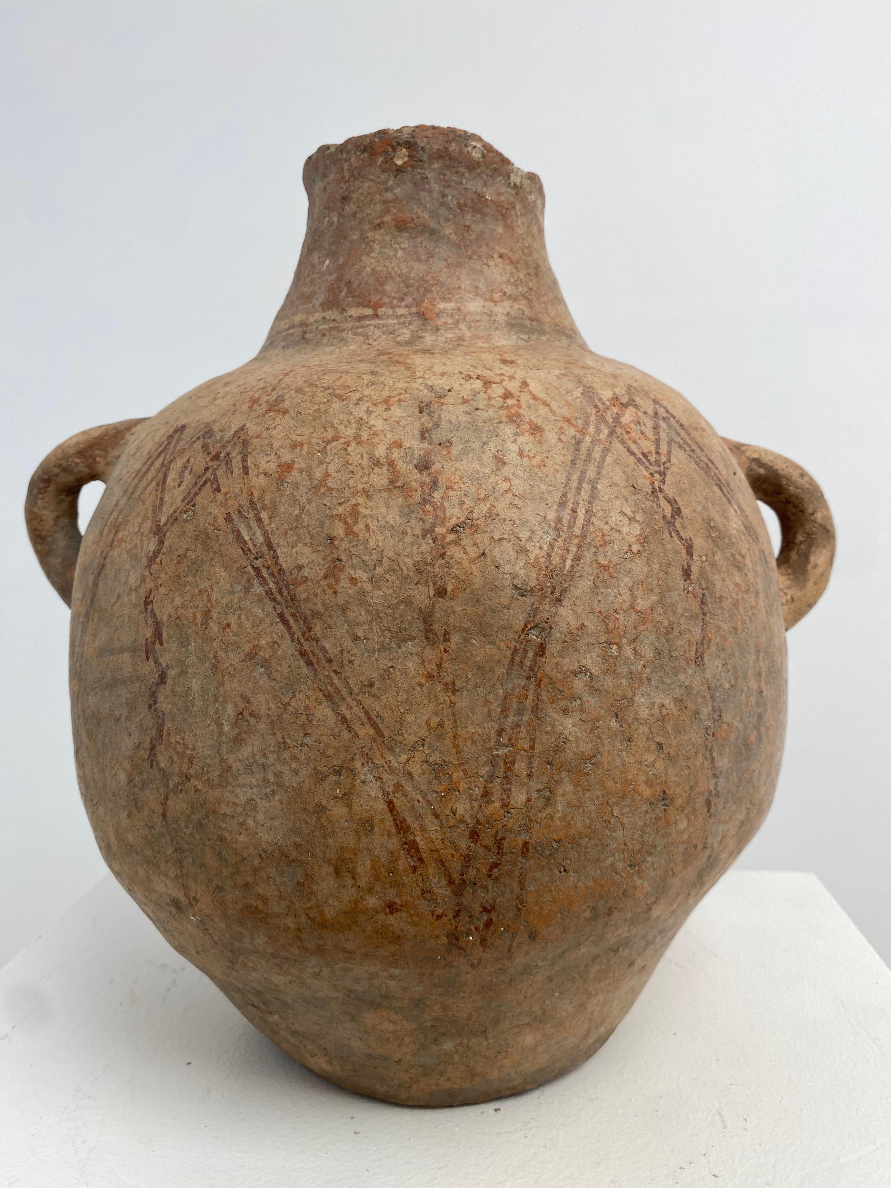 Elegant,antique,brutalist Terracotta Vase with 2 handles from Morocco,
beautiful old patina and shine of the terracotta,
faded Brown/Red  lines used as decoration,
very decorative object