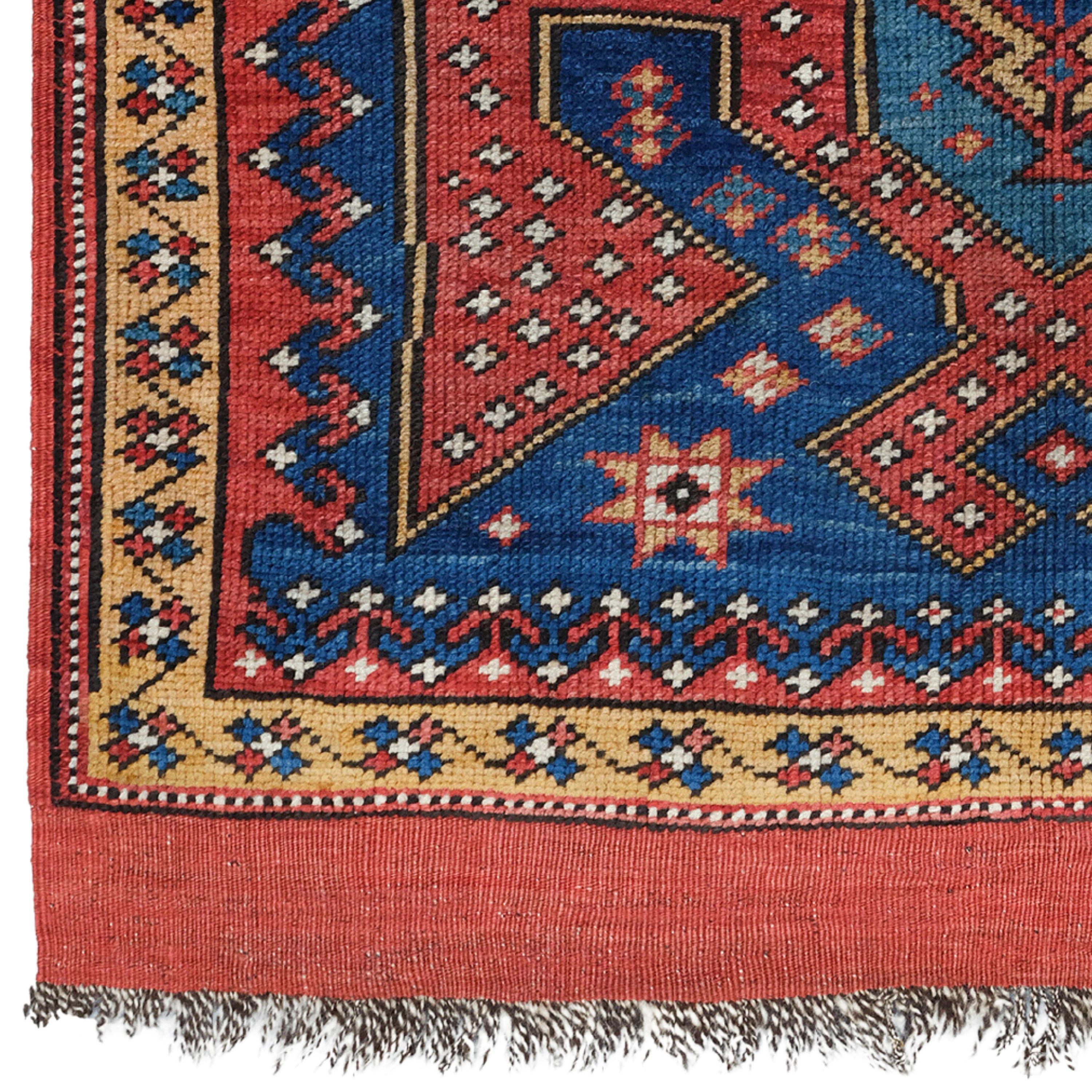 Middle of the 19th Century Anatolian Bergama Rug

In this small rug, a shield motif is surrounded by wide red dotted bands that develop into gables at both ends. It was probably woven in Kozak, which would explain the Caucasian style of the design.