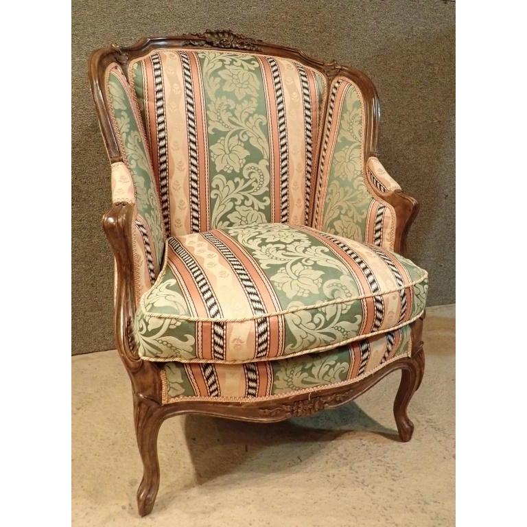 Louis XV style 19th century upholstered bergère fauteuil wingback chair. Hand carved walnut frame.